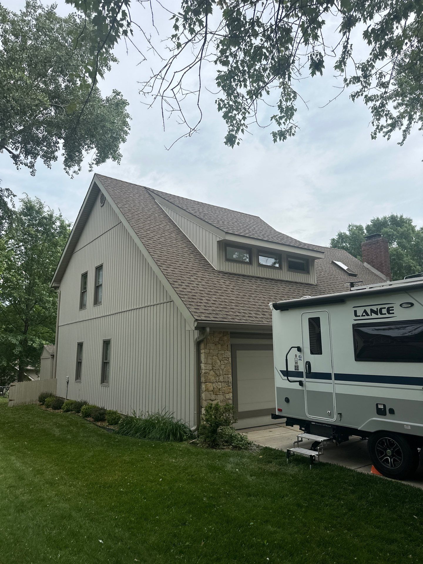 Comprehensive Kansas City Exterior Remodel Featuring Board And Batten Siding by EEC Windows, Siding & Roofing