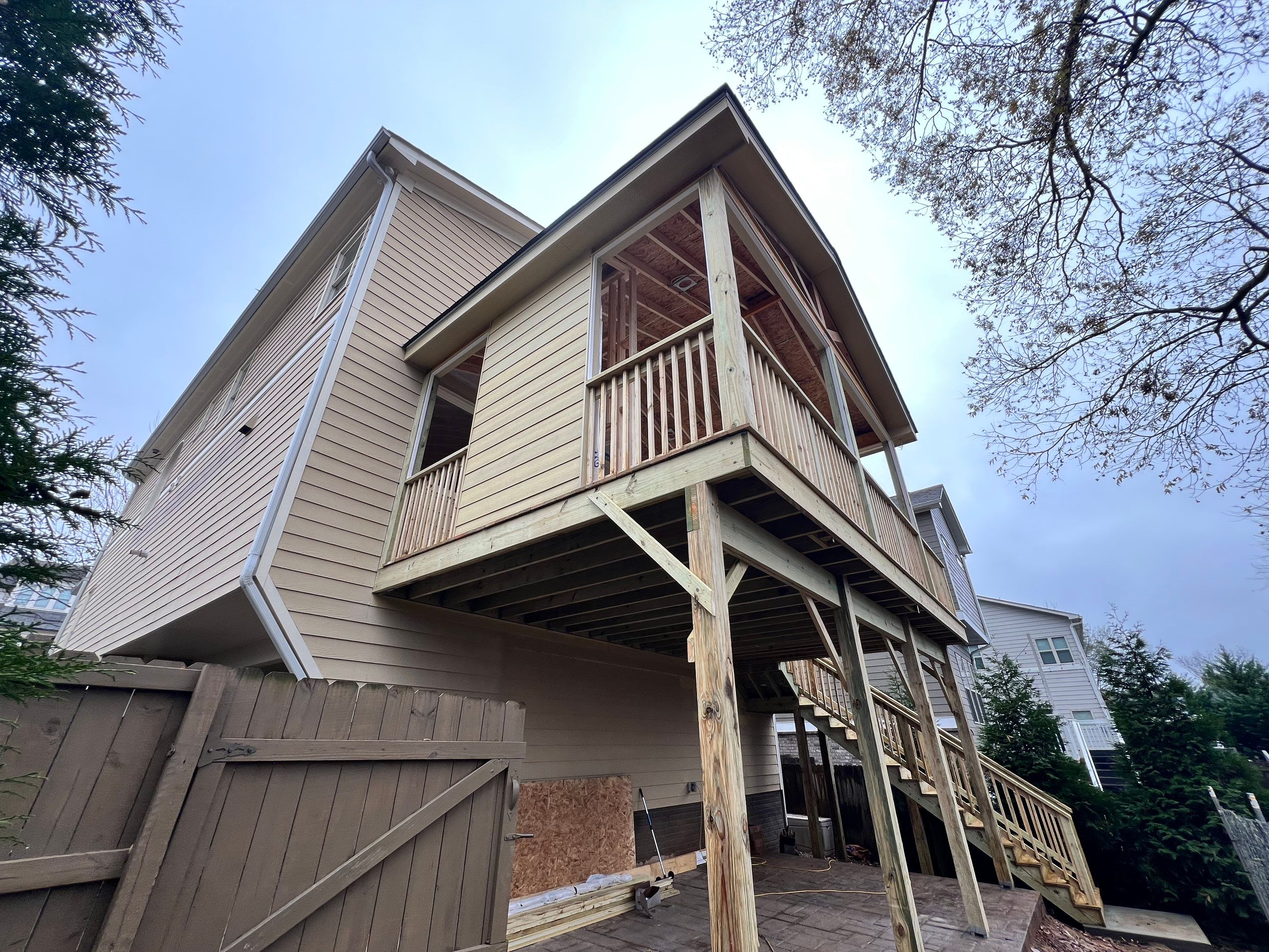 Screened-In Porch With Fireplace by Swift Home Renovations 