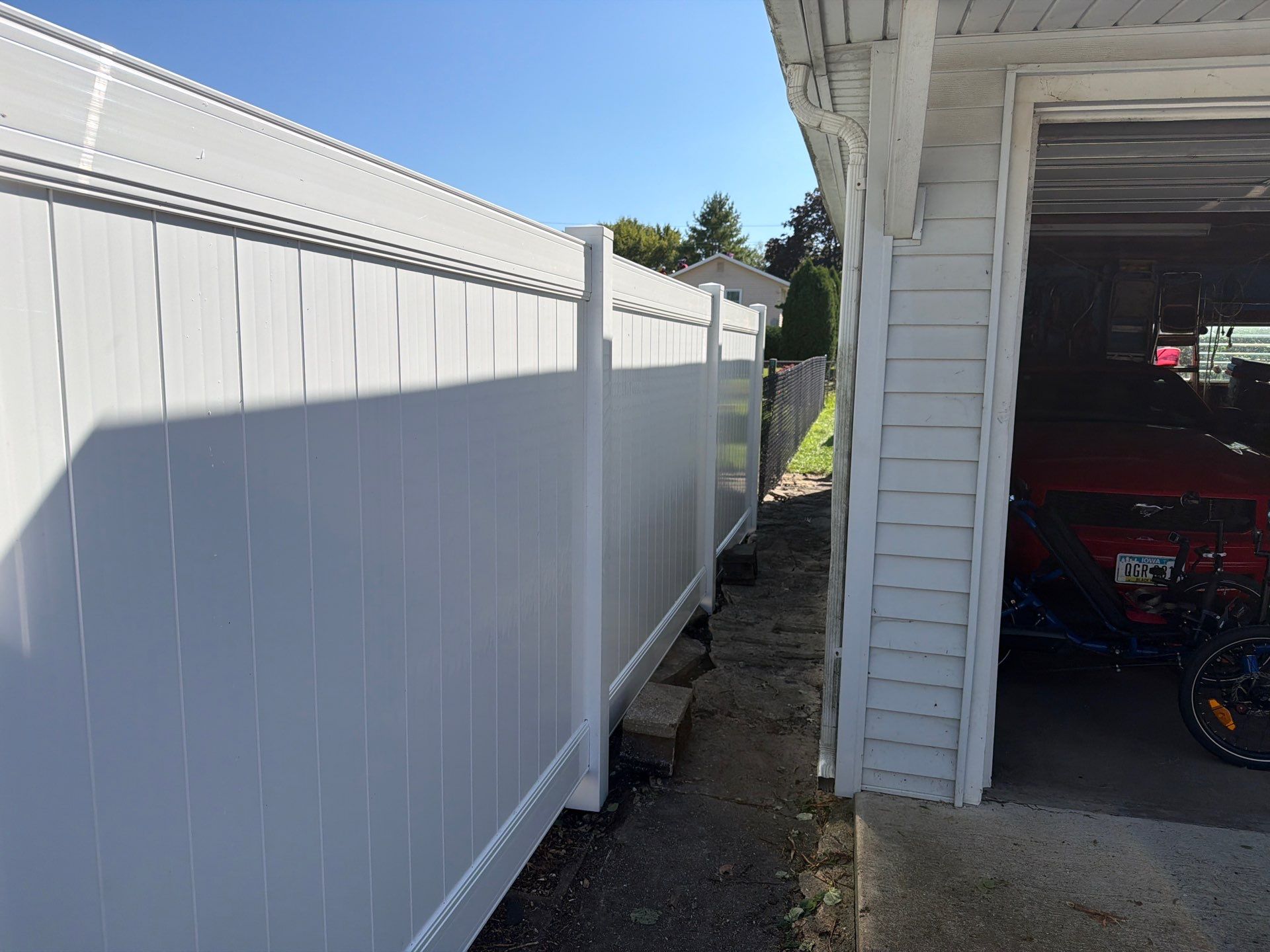 Custom Vinyl Privacy and Black Chain Link Fence Installation in Cedar Falls by Perfect Picket Fence and Stain