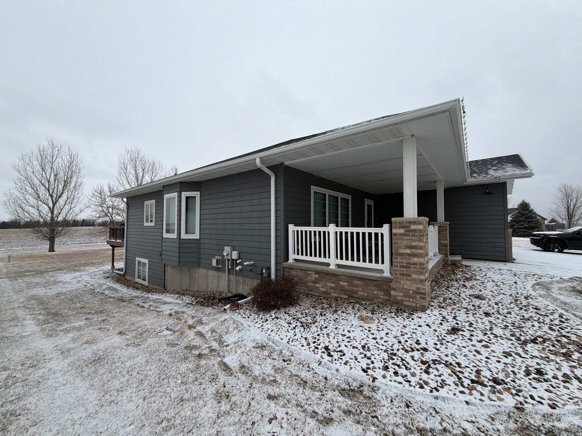 Madison Exterior Remodel with Dark Gray Siding and Stone Accents by Select Painting, Coatings & Garage Cabinets