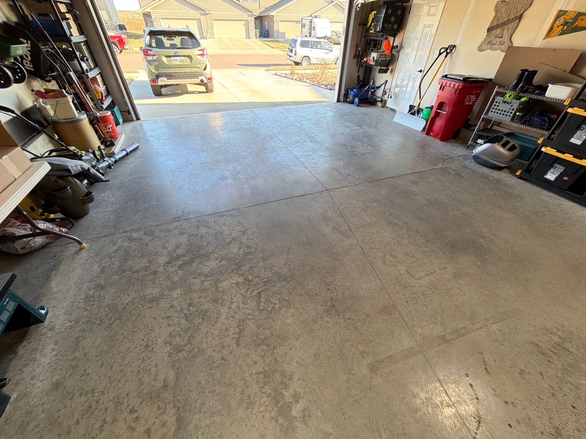Sioux Falls Garage Floor Transformation With Gray Speckled Epoxy Coating by Select Painting, Coatings & Garage Cabinets