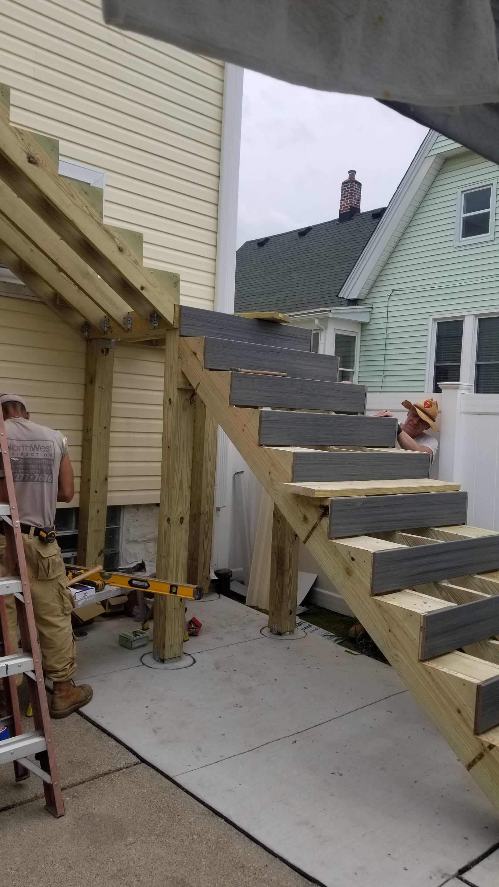 Rebuild balcony flat roofing TREX decking stairway and Railings in Wyandotte, MI by Northwest Construction 