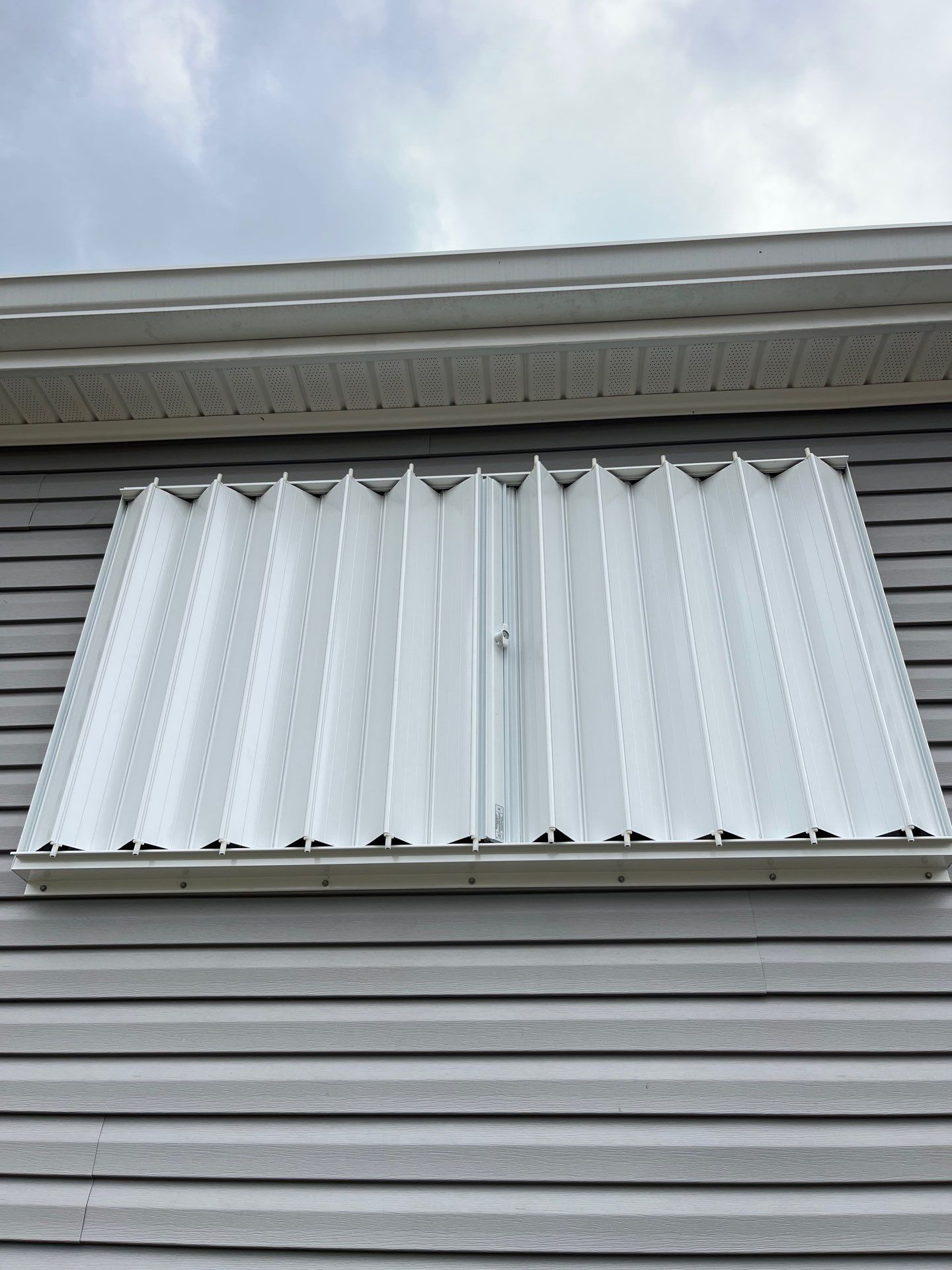 Residential Accordion Hurricane Shutter Installation in Fountain, Florida by Brannan Aluminum Inc.