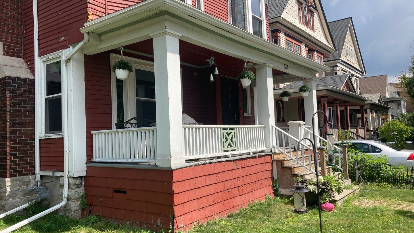 Exterior Renovations- Siding, Stamped Concrete, Porch, and Railings by Ivy Lea Construction
