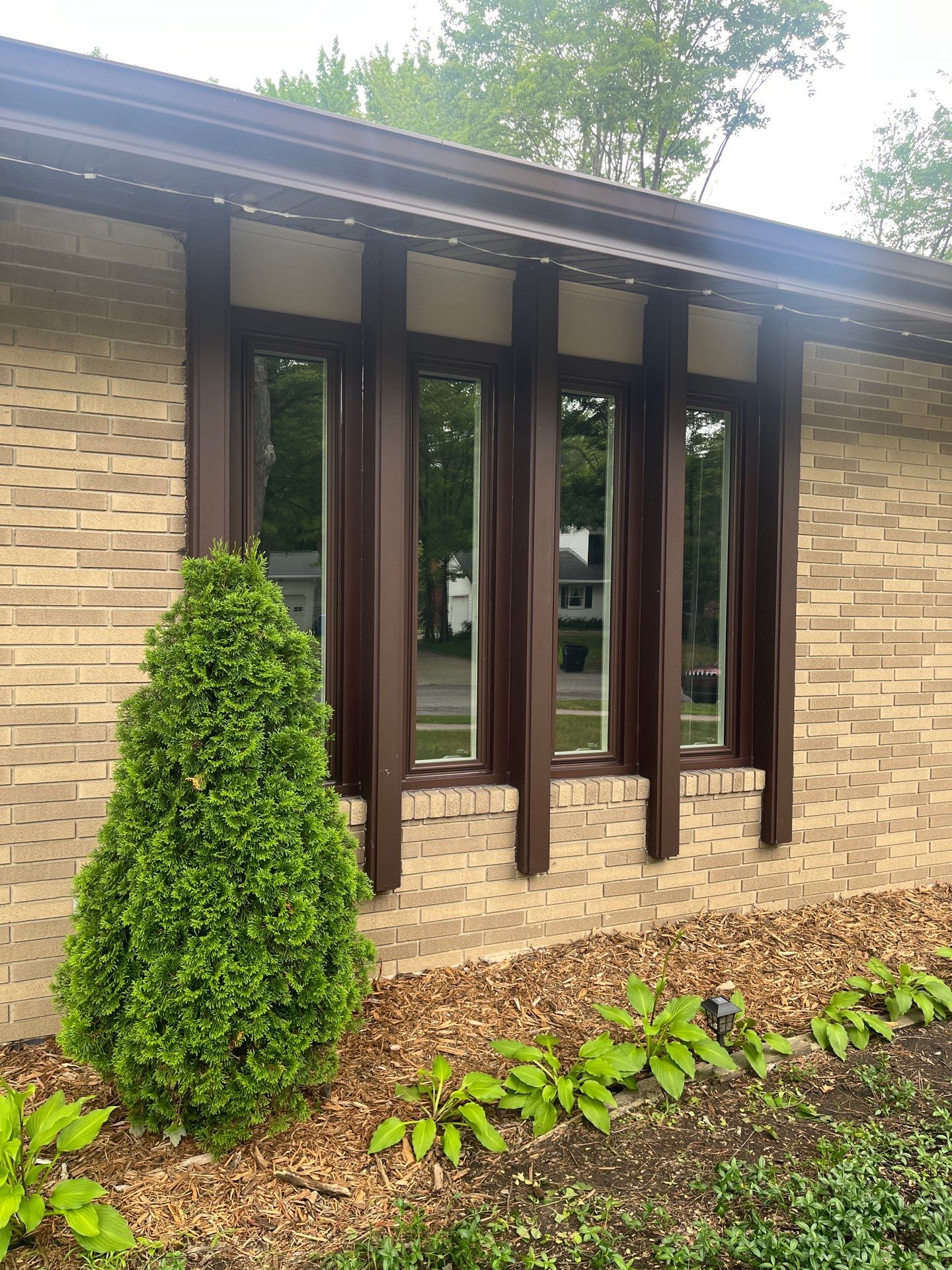 Dark Brown Window Installation for Midland Brick Ranch Home by Great Lakes Home Design LLC