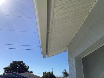 New White Seamless Gutters with Downspouts and Splash Guards in Cape Coral FL