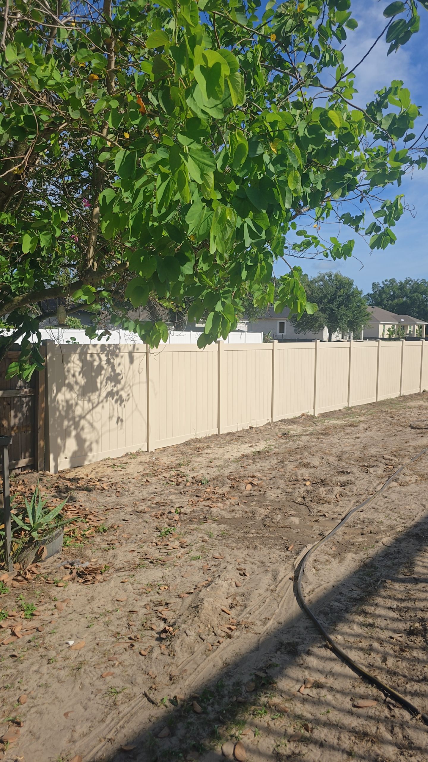 Tan Vinyl Privacy Fence and Gate Installation in North Port by True Fence LLC