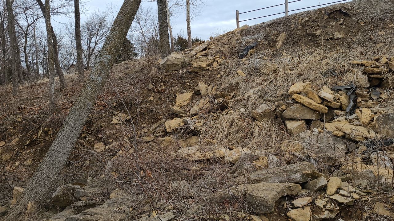 Supporting back of home with backfill at edge of steep creek by LAND ESCAPES LLC