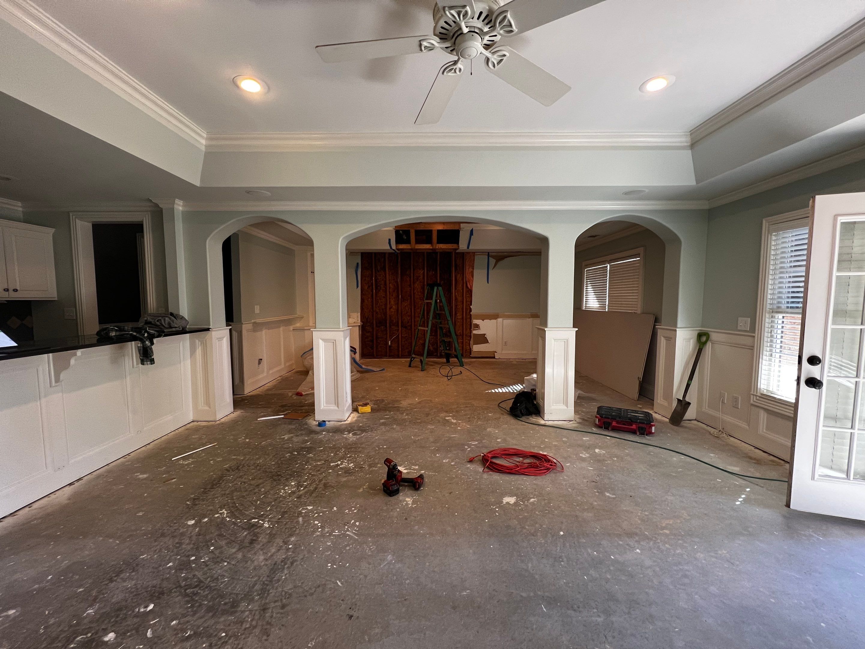 Finished Basement Remodeling with Dark Wood-Look Flooring and Custom Wainscoting by Swift Home Renovations 