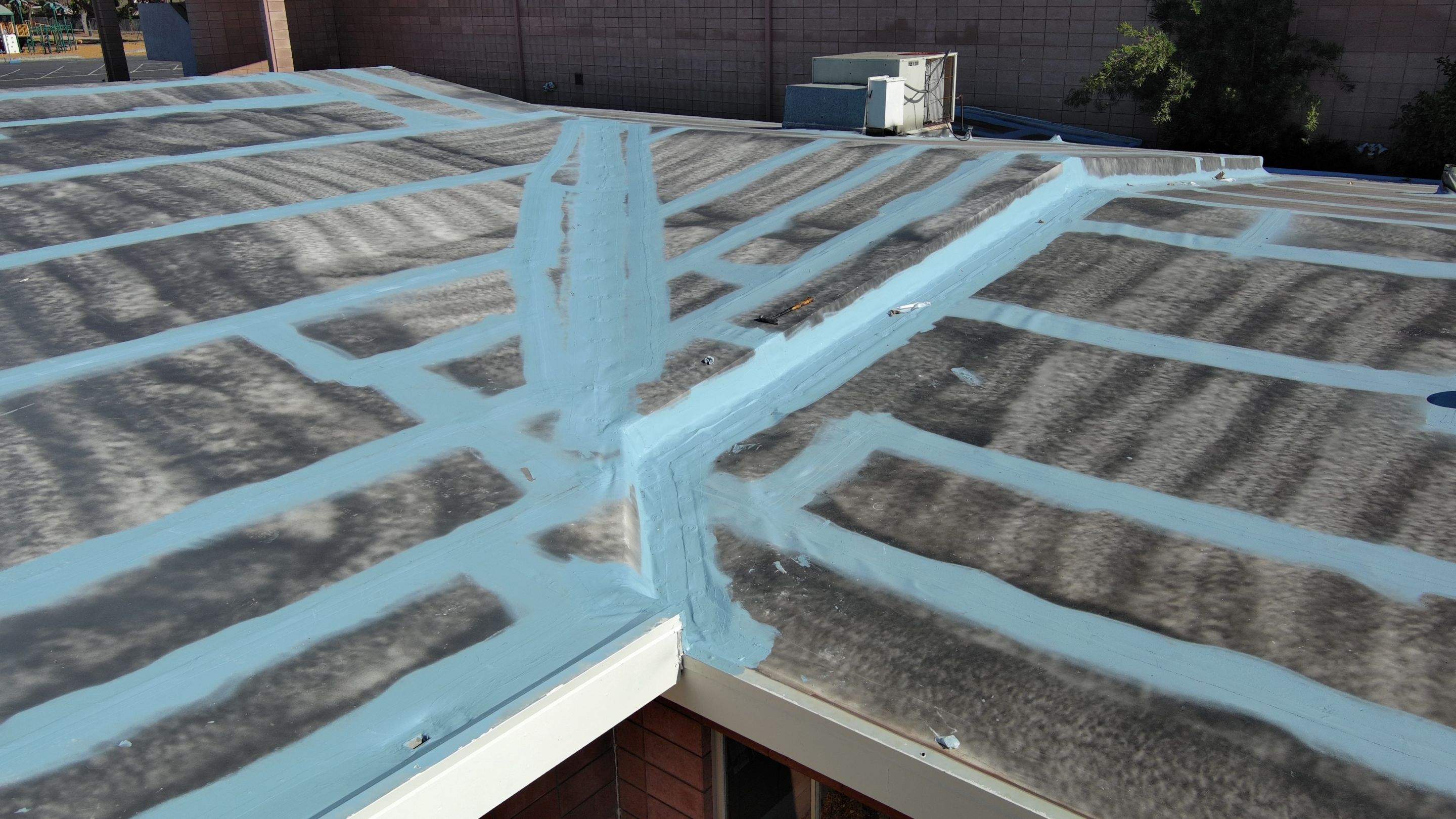 Single-ply restoration system using Benchmark/PUMA XL coatings over TPO single-ply roofing by Straight Edge Roofing Inc