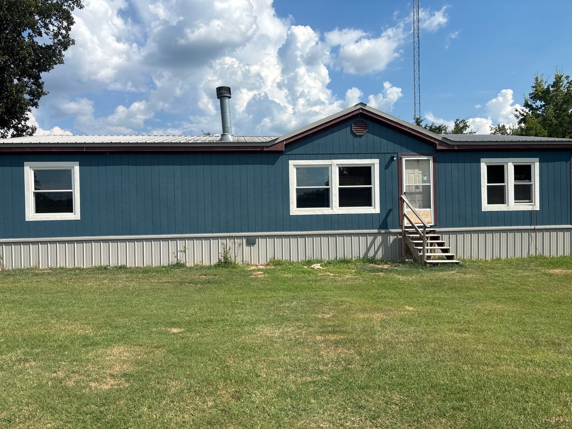 Exterior Painting in Fruitvale, TX | Wood Porch & Home in Deep Navy Blue by Quality Coats Painting