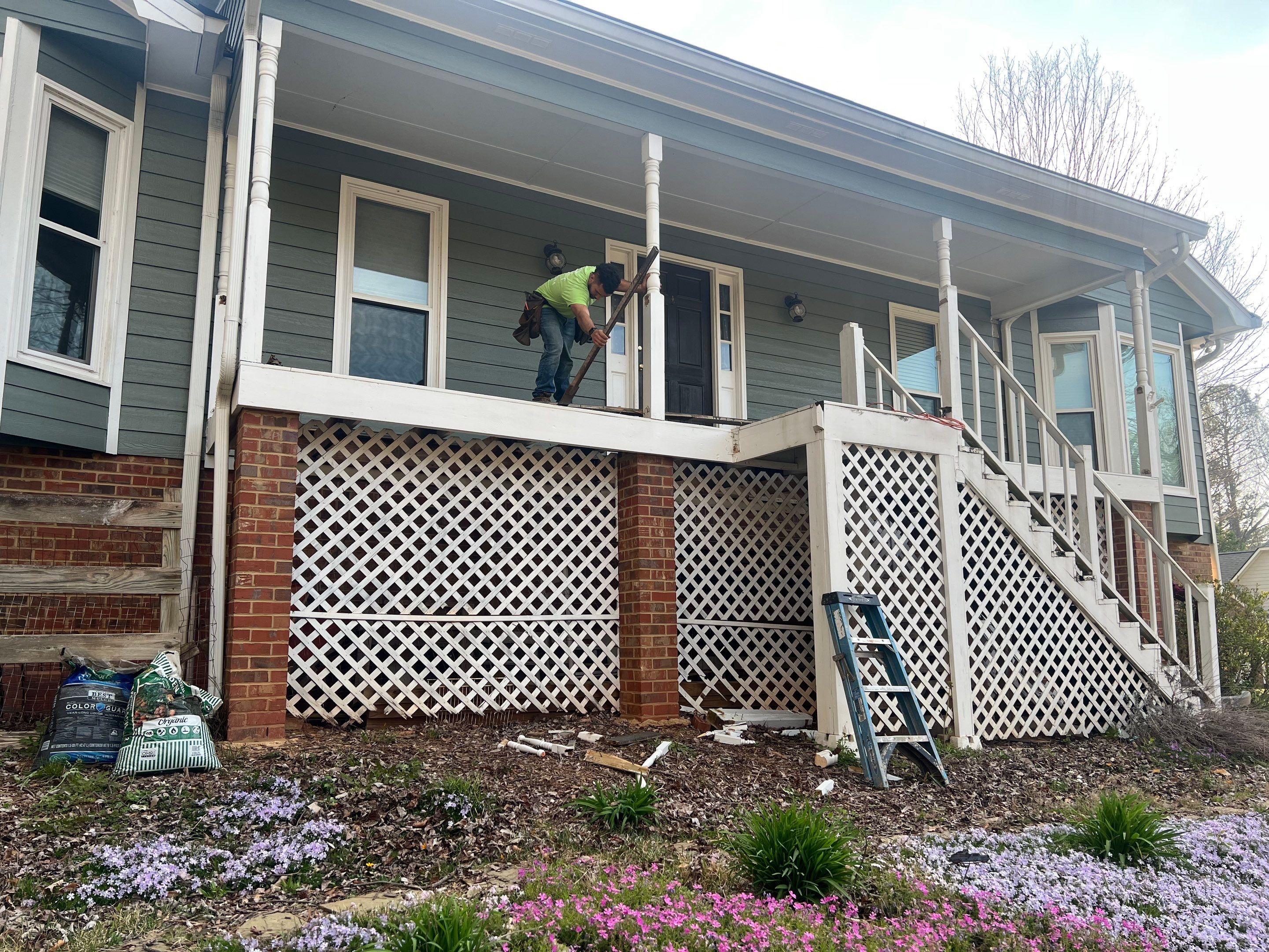 Composite Deck and Porch Renovation With Black Metal Railings by Swift Home Renovations 