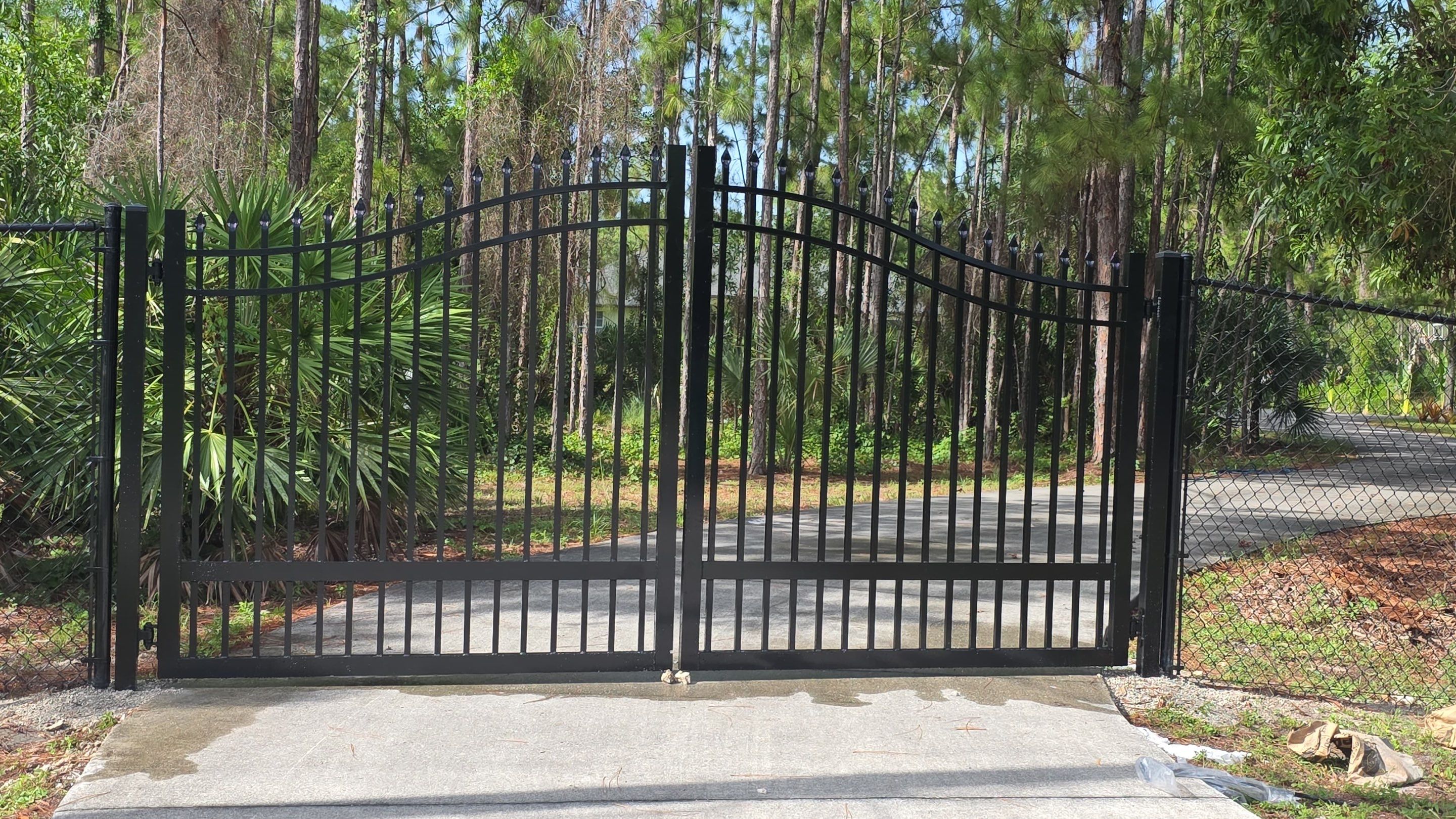 Automated Driveway Gate and Black Chain Link Fence Installation by True Fence LLC