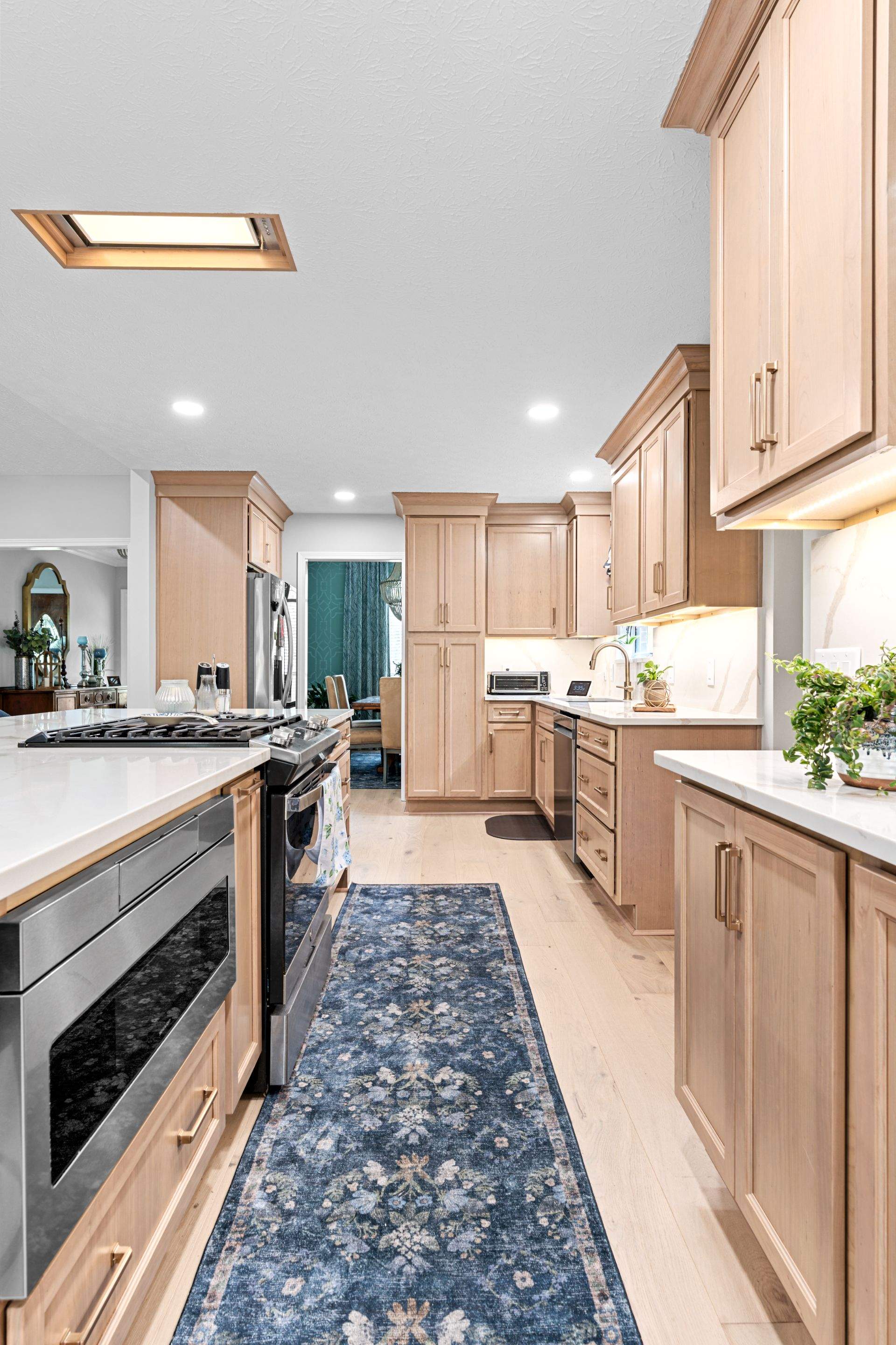 Modern Kitchen Remodel Featuring Quartz Backsplash, under cabinet lighintg, and a coffee bar in Mt. Juliet Tennessee by DeRo Renovations,LLC