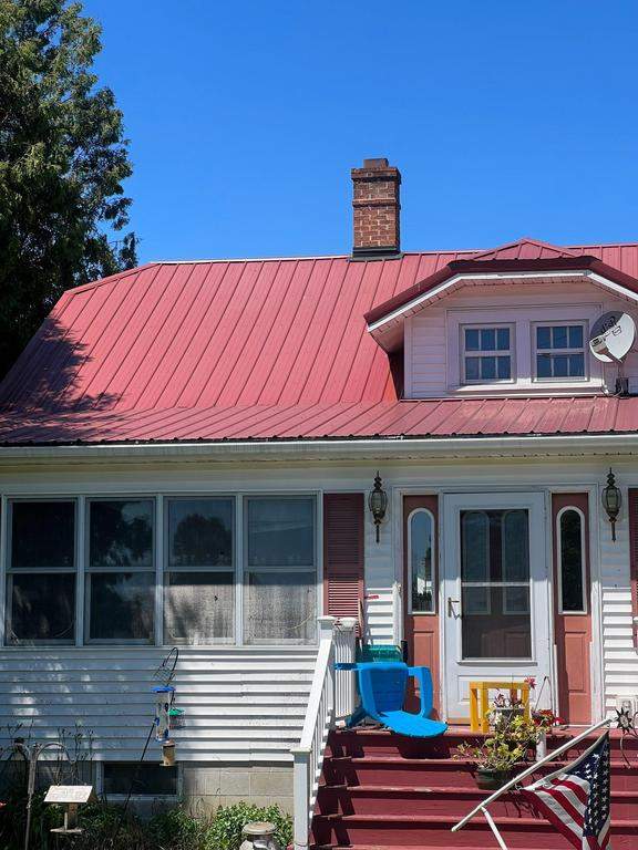 Residential Roof Installation with Red Pro Rib Metal Roofing in Adell, WI by Gellings Roofing & Siding