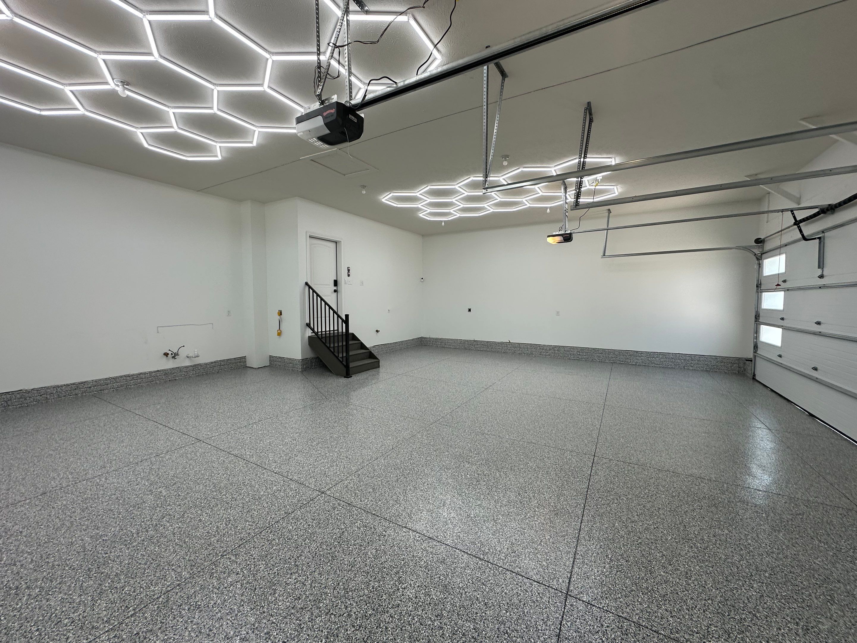 Three-Stall Garage Epoxy Floor Coating and LED Lighting in Lincoln by Goat Coatings