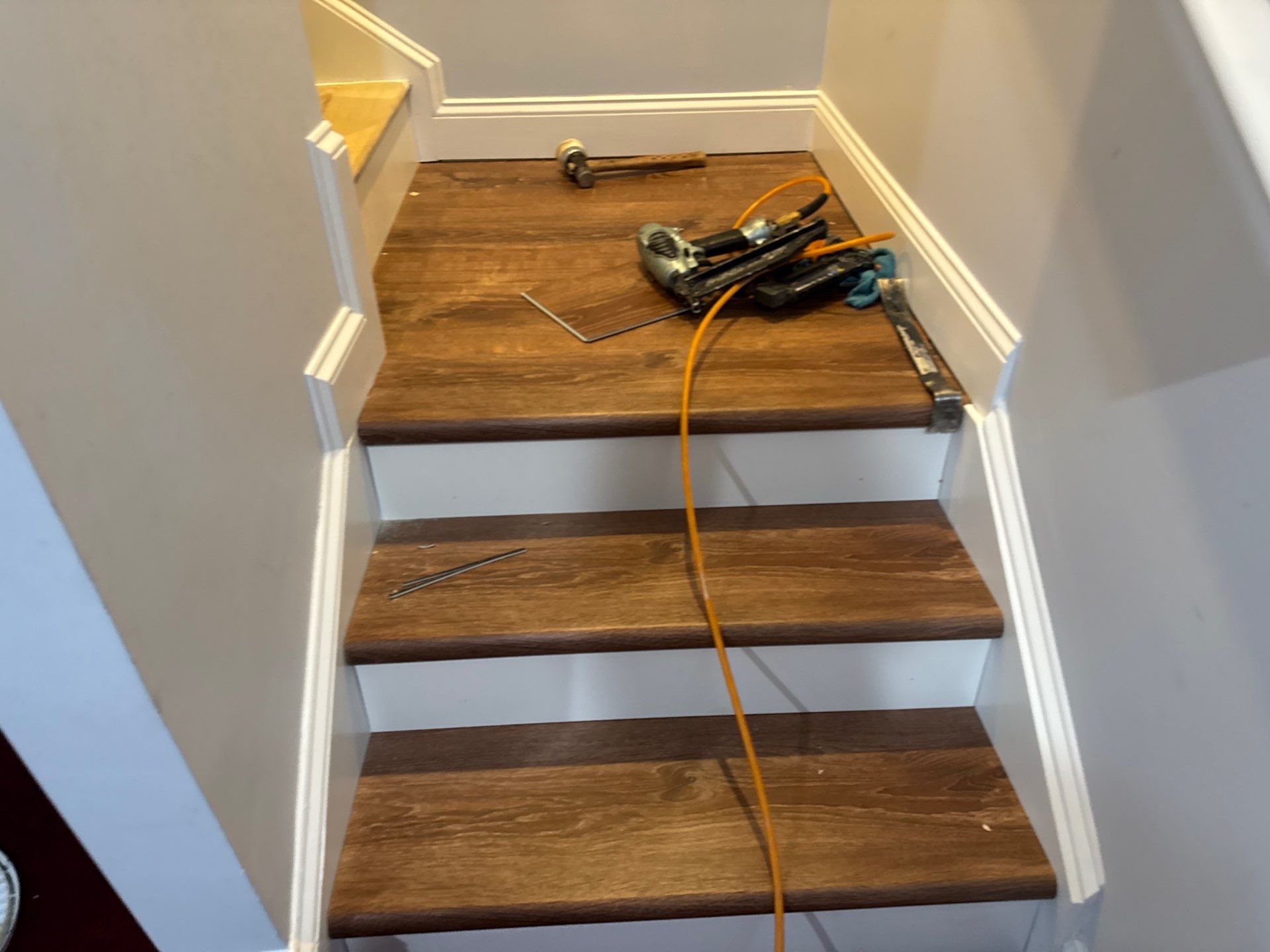 Stairway Installation using t vinyl stair tread and reversibleriser by La Bendicion Contruction Llc