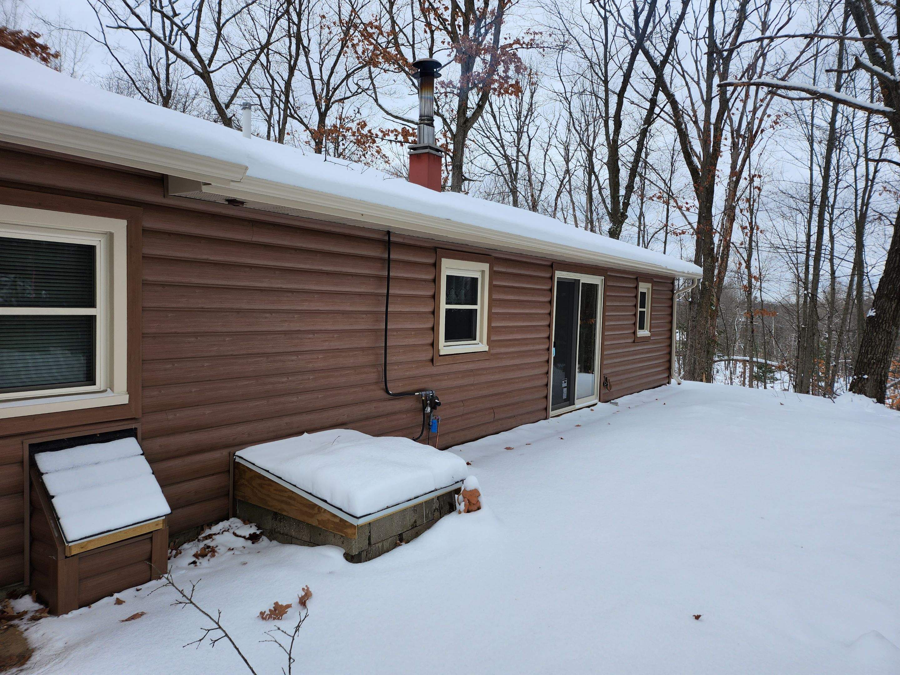 New addition and log siding by Energy Plus Home Improvements