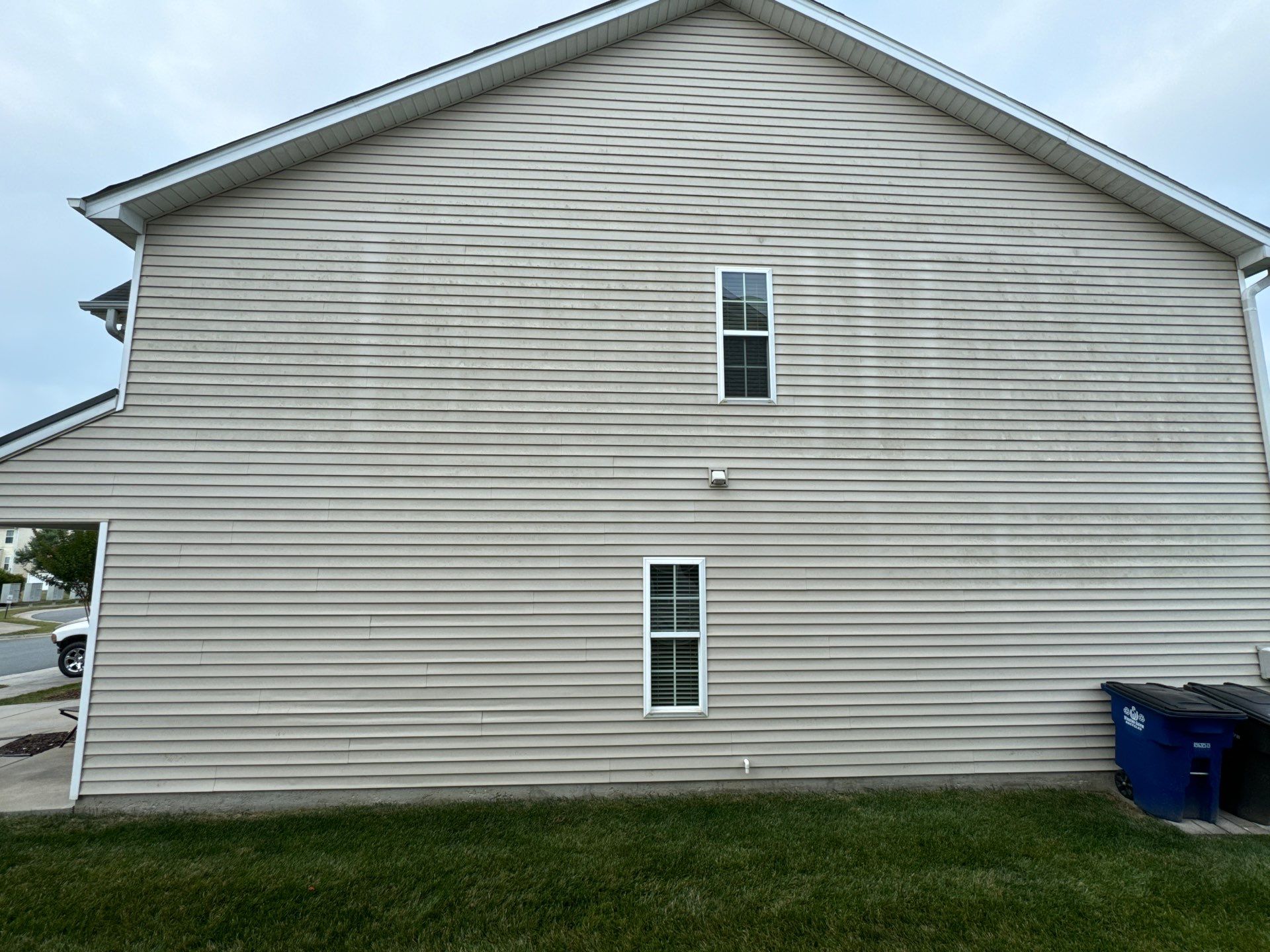 pressure washing exterior siding to remove dirt and maintain the appearance of the home