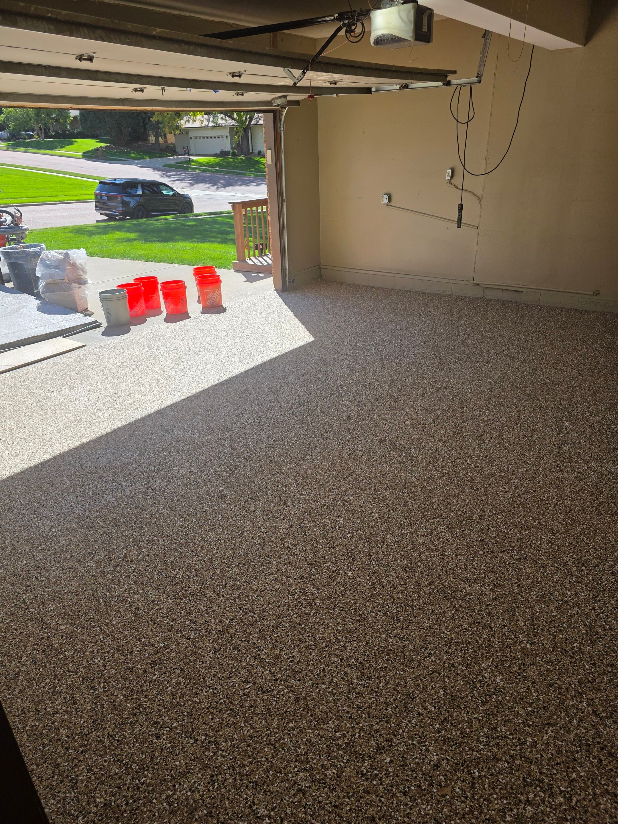 Residential Garage Epoxy Floor Coating Installation in Sioux Falls by Select Painting, Coatings & Garage Cabinets