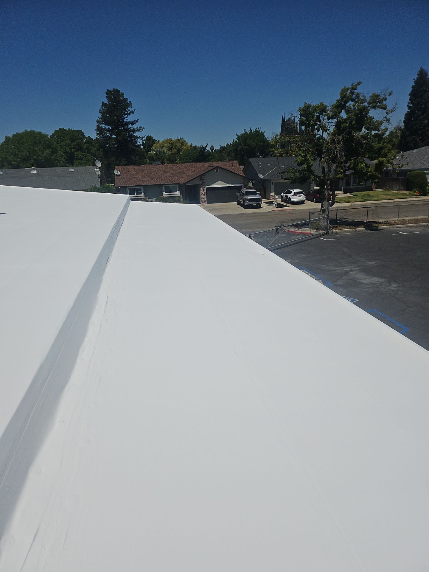 Single-ply restoration system using Benchmark/PUMA XL coatings over TPO single-ply roofing by Straight Edge Roofing Inc