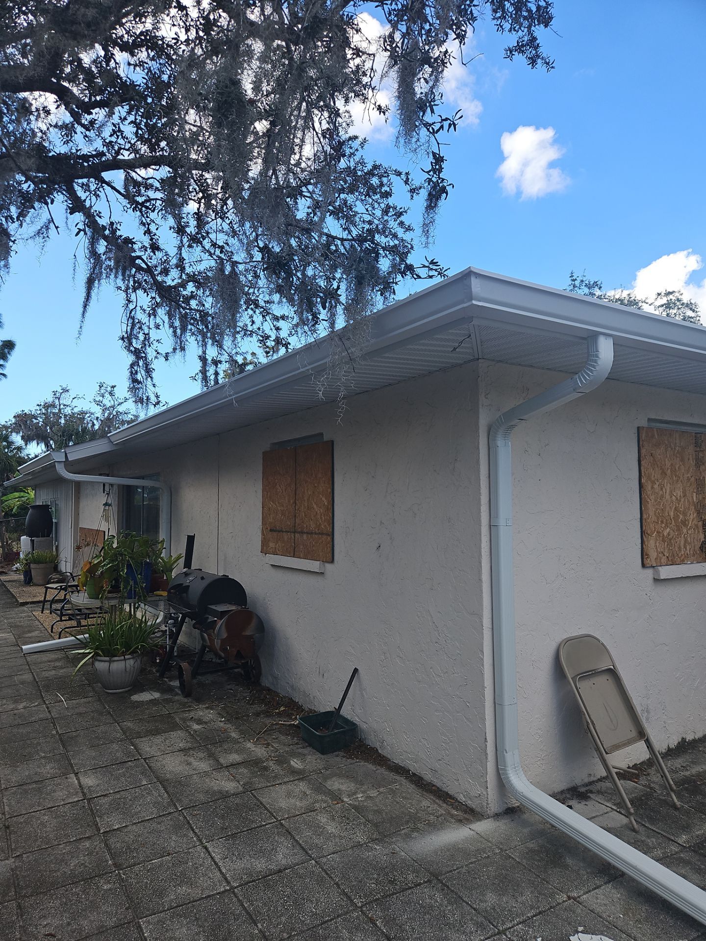 Downspout Installation using White Down Spouts in Sarasota FL by Gutter Professors