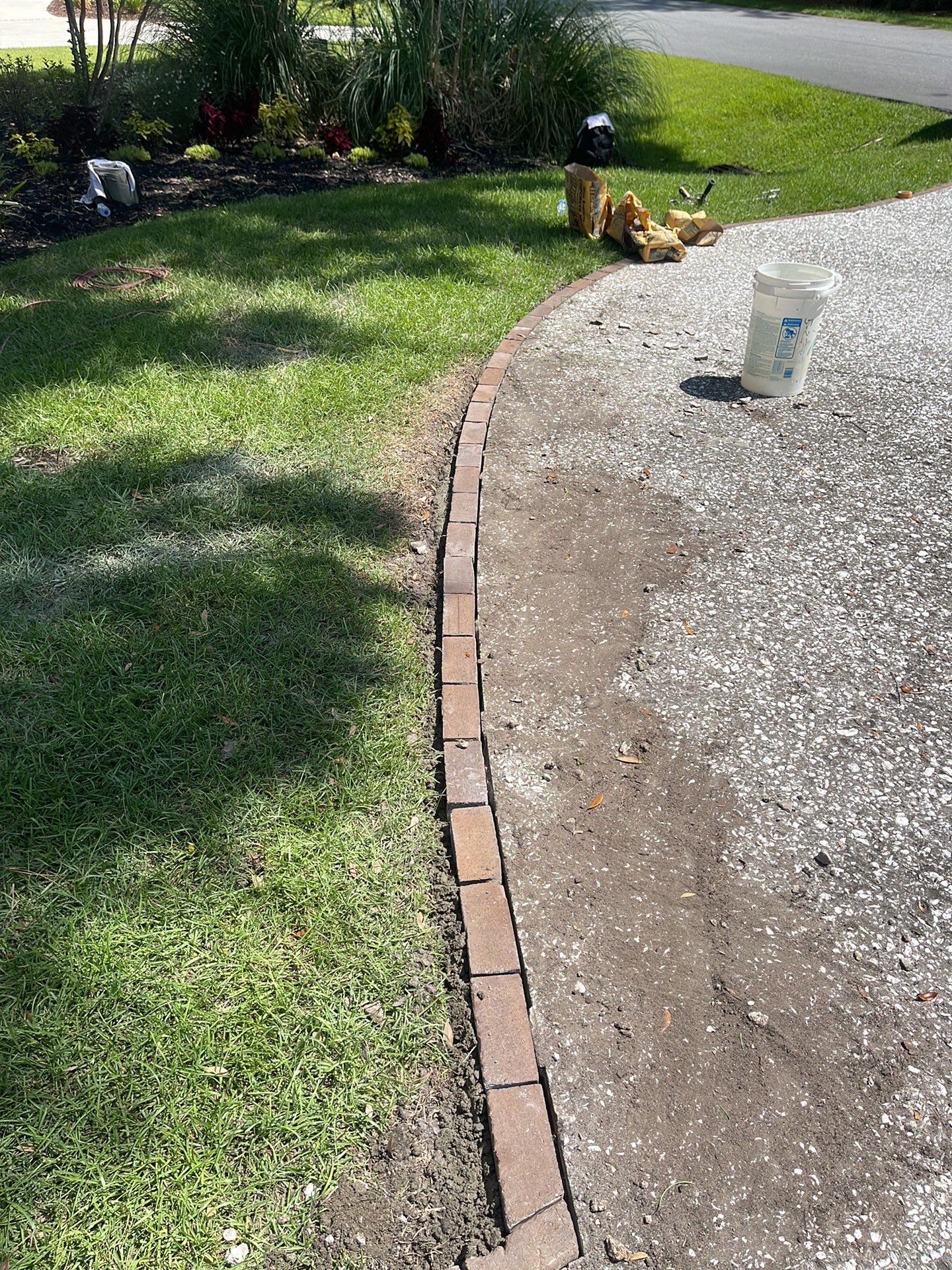Custom Exposed Aggregate Driveway with Red Brick Borders in Hilton Head Island by Lowcountry Scapes, LLC