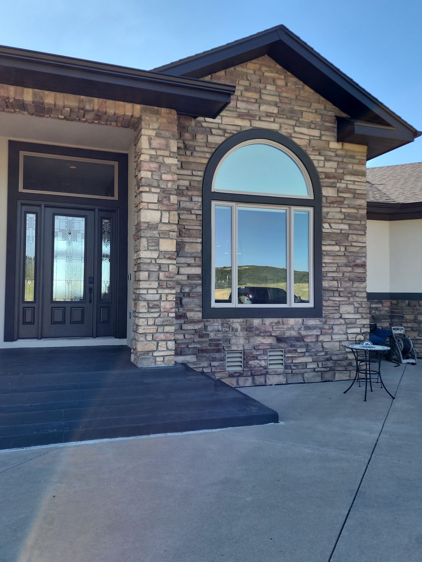 Castle Rock Elegance: White Stucco Exterior with Bold Tricorn Black by J&M Painting LLC