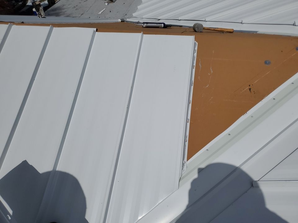 Residential Roofing Installation using 1.5" Nail Strip 24ga Solar White Kynar Coated Standing Seam Metal Panels by Morton Roofing, Inc.