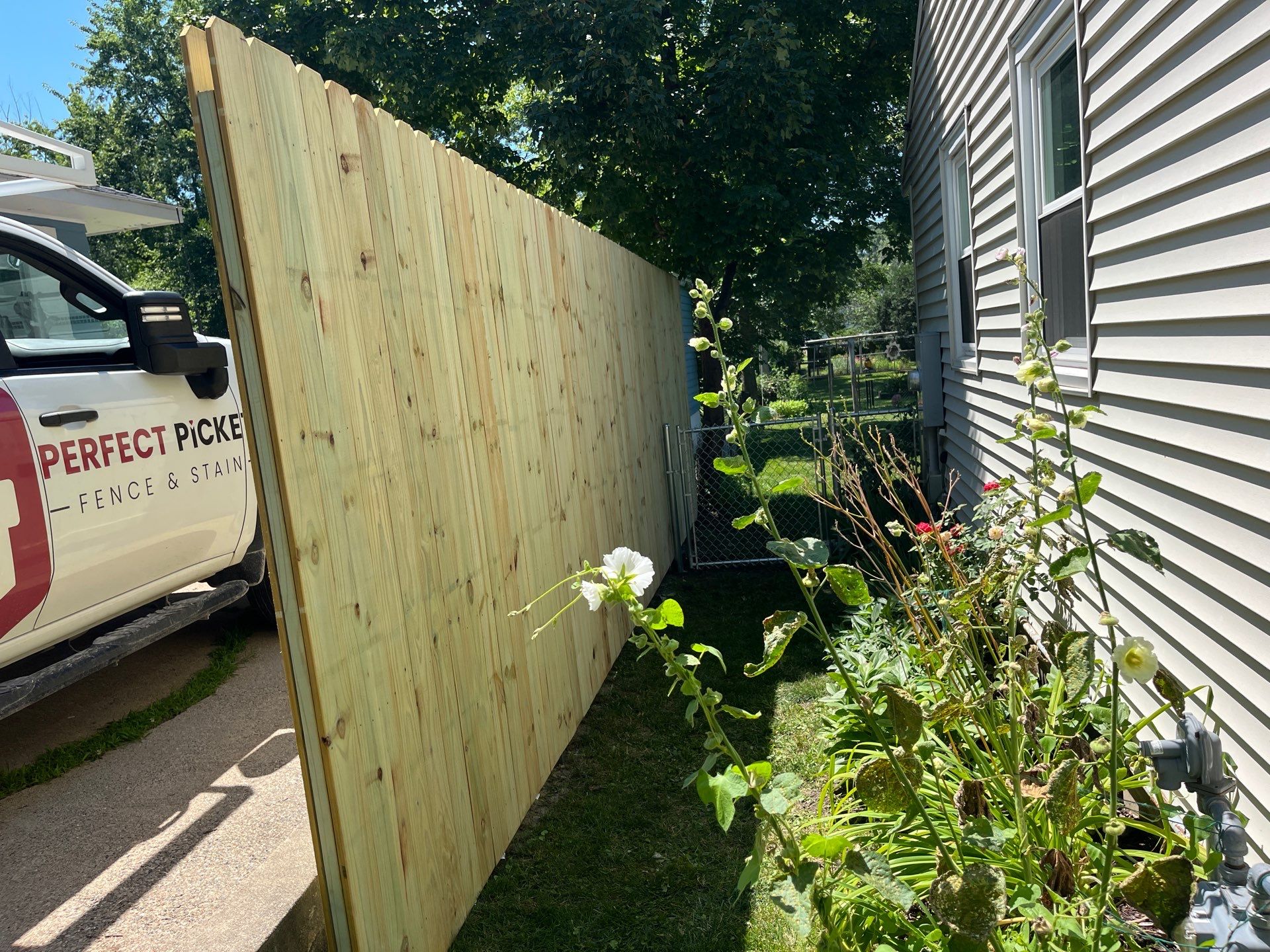 Pressure-Treated Wood Privacy Fence Installation in Cedar Falls by Perfect Picket Fence and Stain