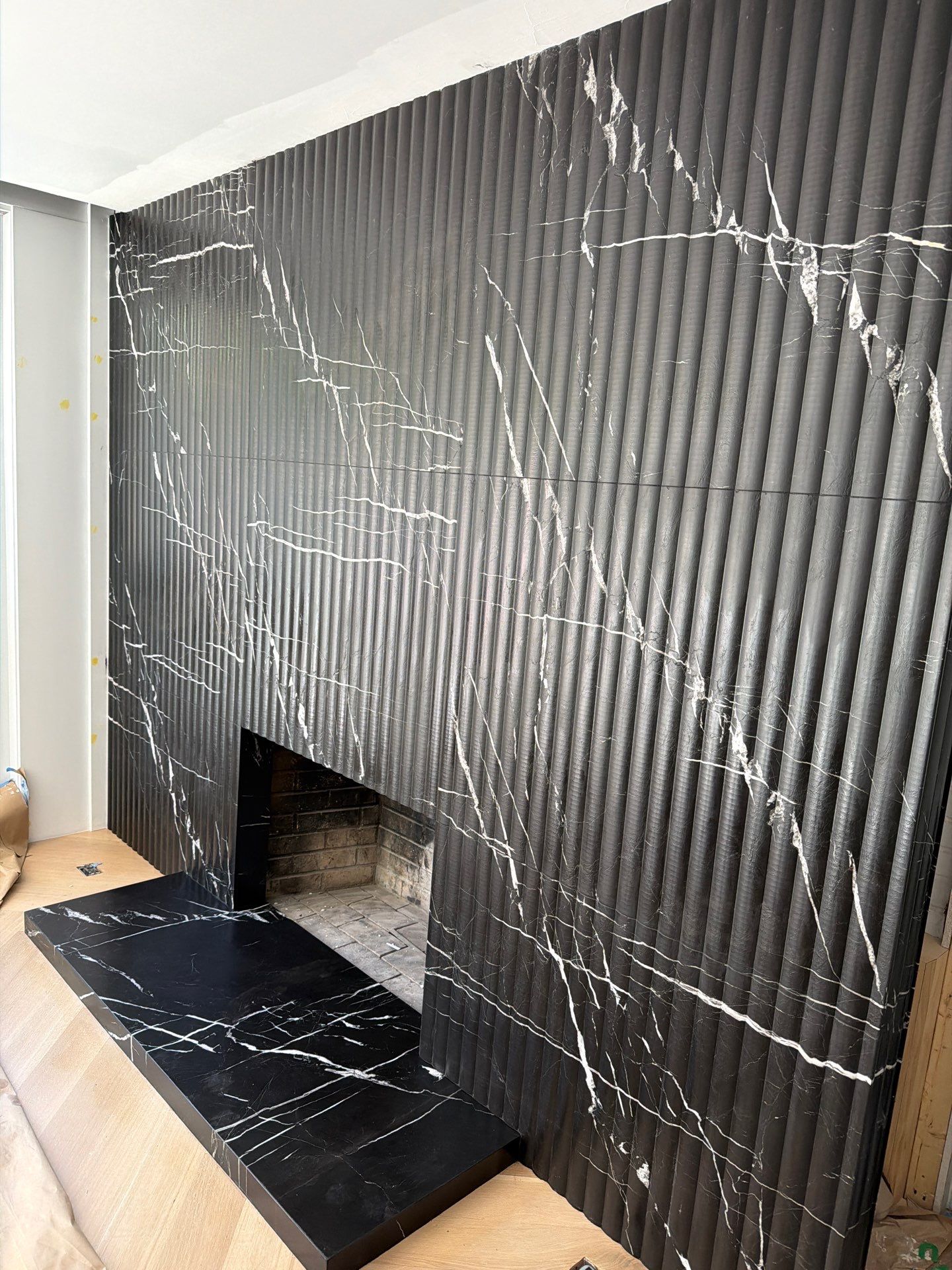 Full-Height Fluted Marble Fireplace Wall by NC Stone And Tiles