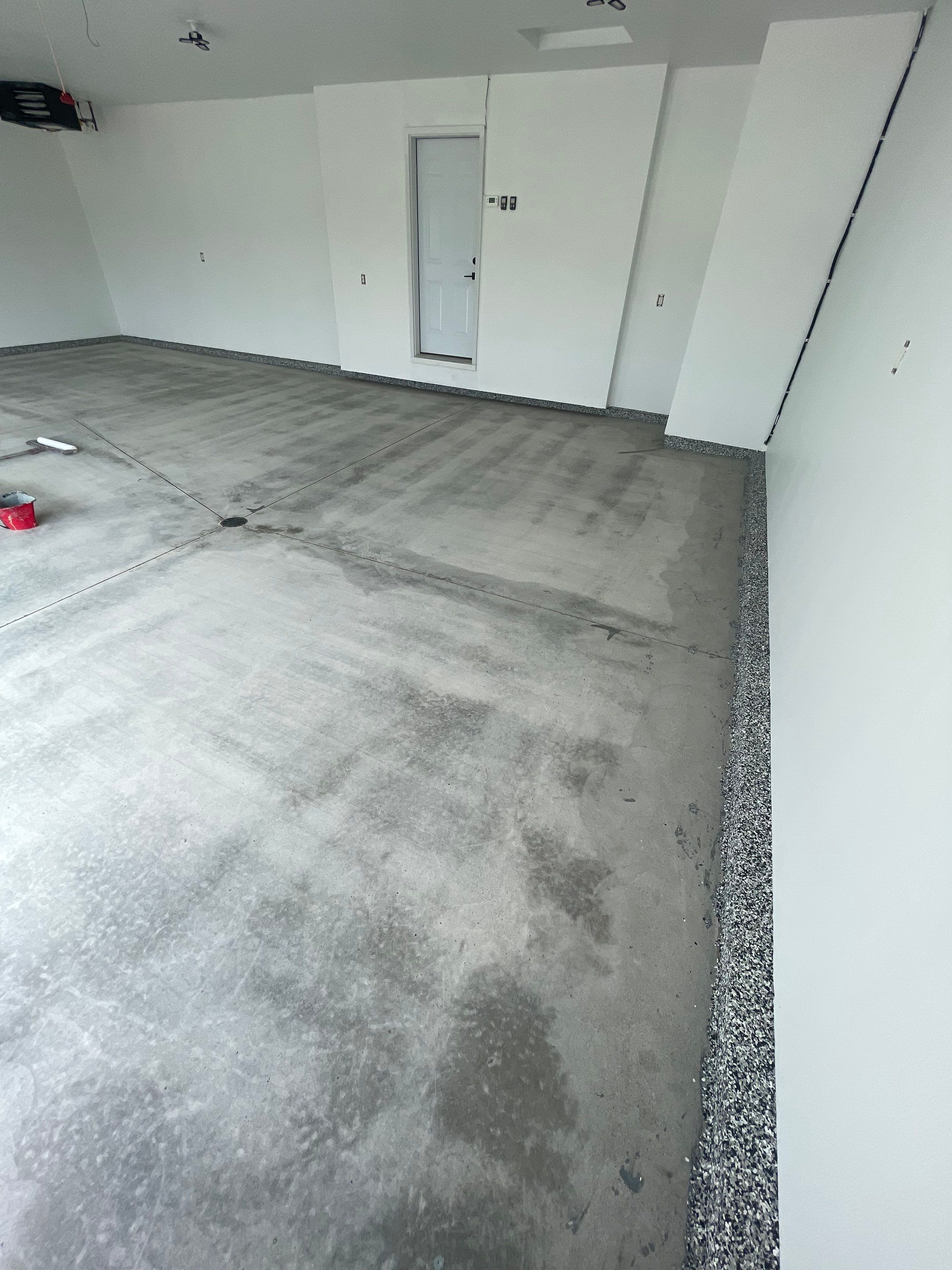 Grey Flake Epoxy Garage Floor Coating in Sioux Falls by Select Painting, Coatings & Garage Cabinets
