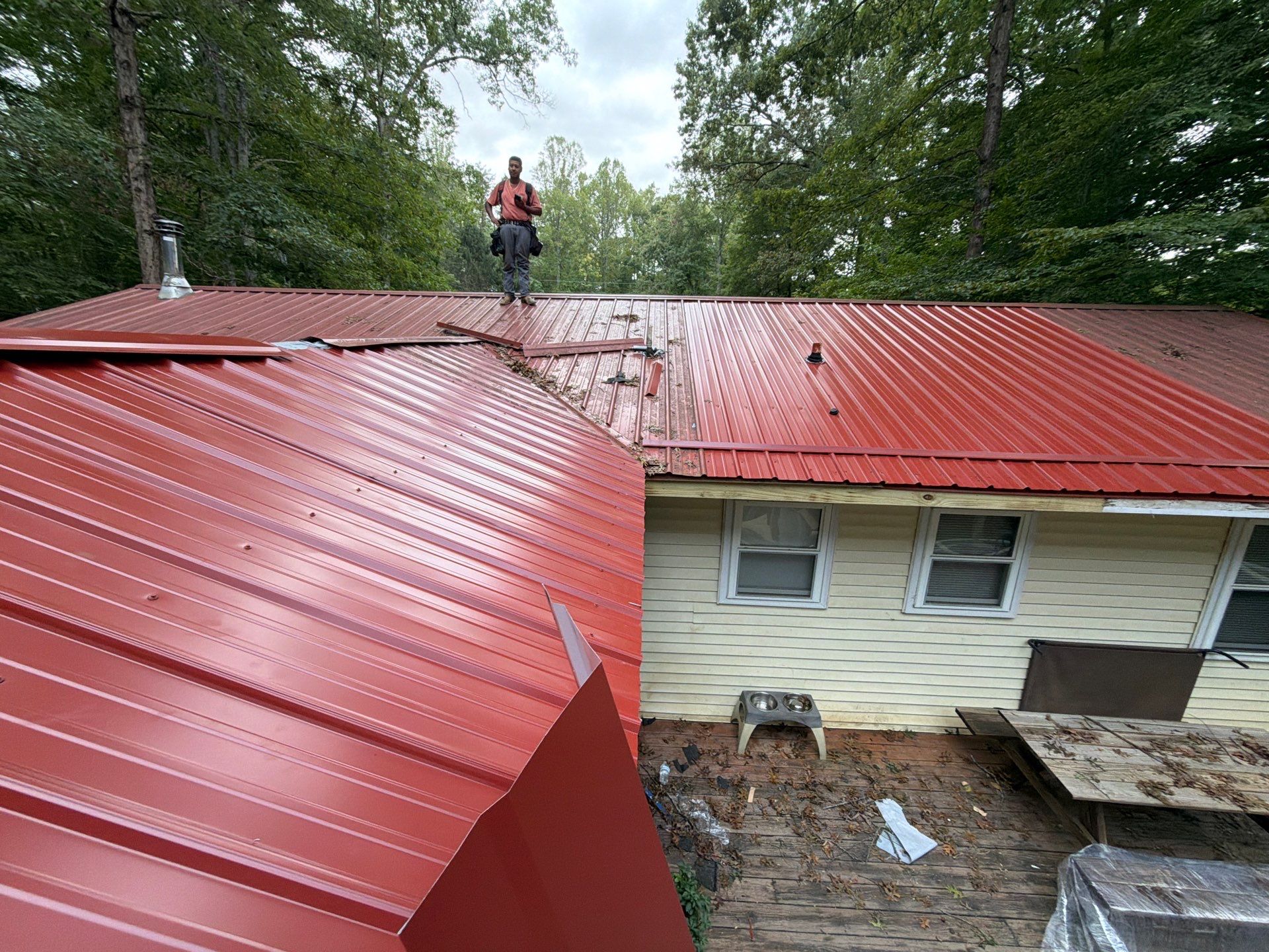 Red Metal Roof Restoration and Wood Fascia Replacement in Barboursville by Cade Construction