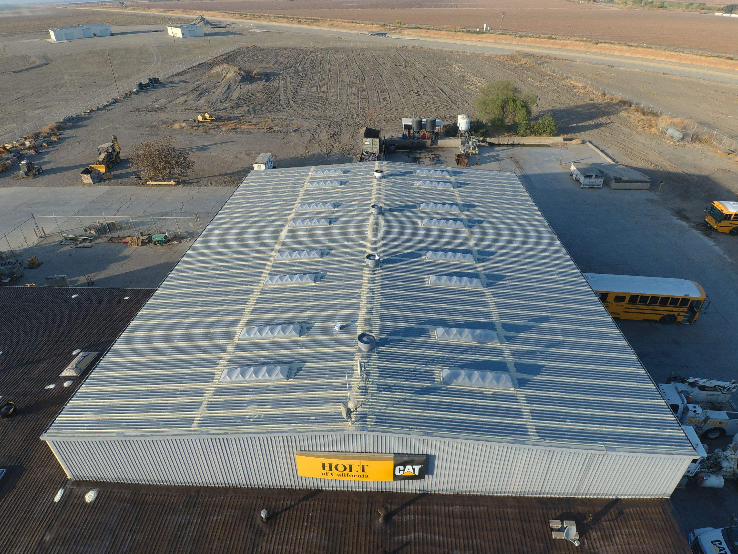 Metal roof restoration on commercial roof using Conklin Benchmark/ PUMA XL acrylic coatings over metal and foam by Straight Edge Roofing Inc