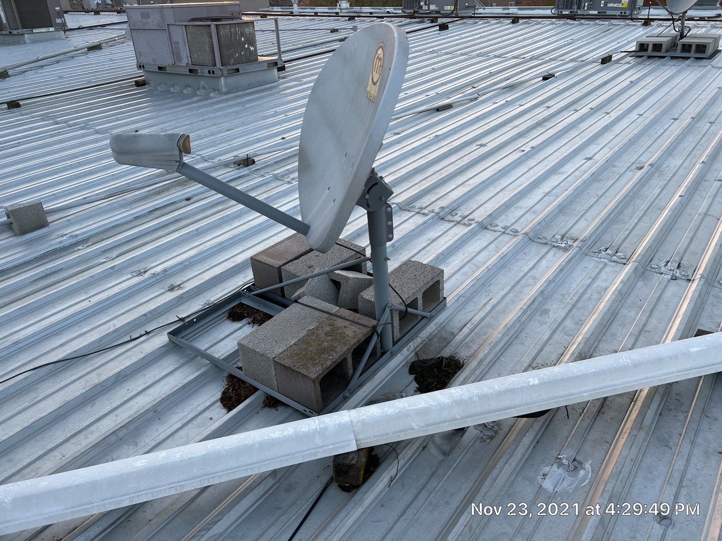 Metal roof restoration on commercial roof using Conklin Benchmark/ PUMA XL acrylic coatings over metal and foam by Straight Edge Roofing Inc