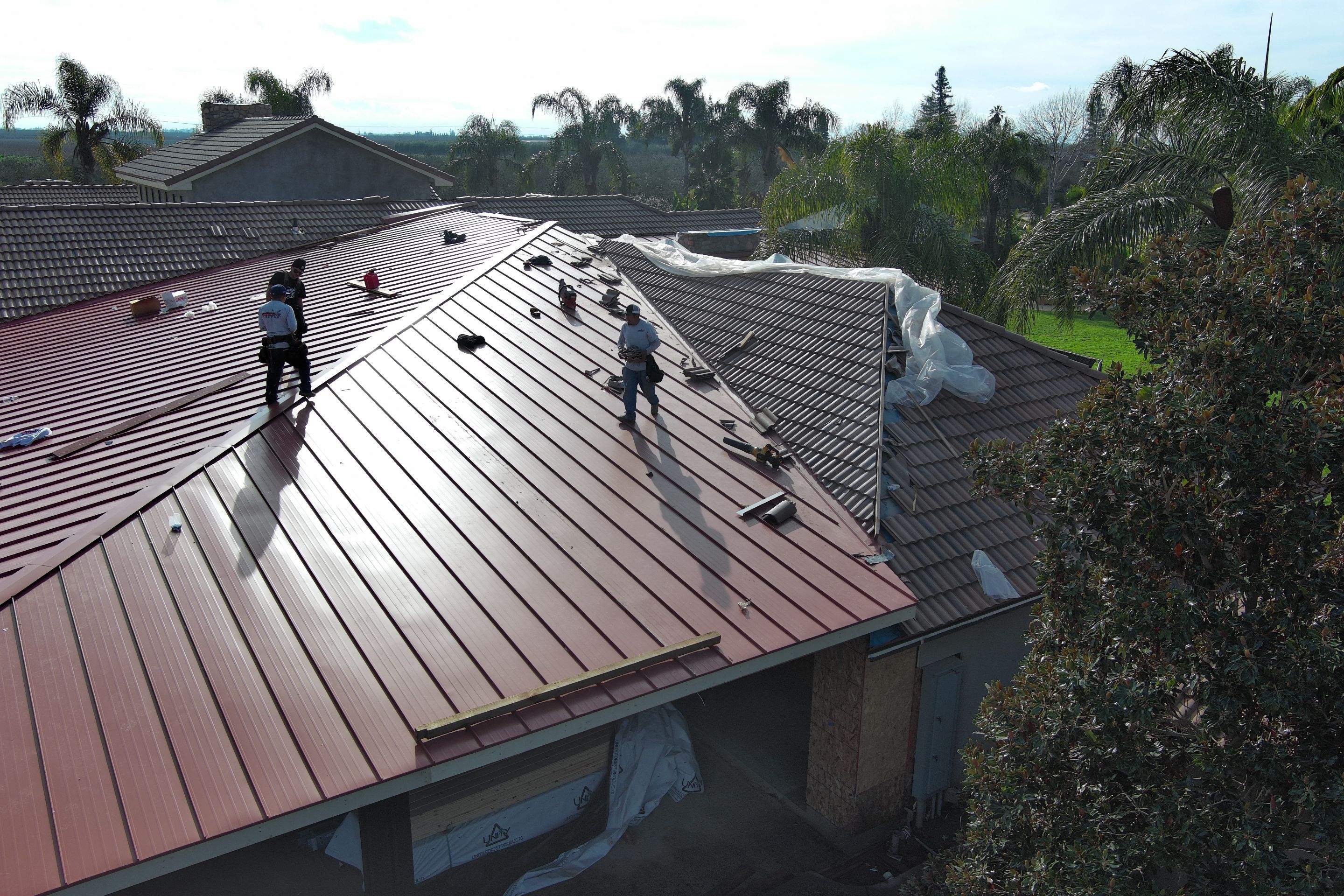 Tile, Metal, and TPO roofing project (new construction) by Straight Edge Roofing Inc