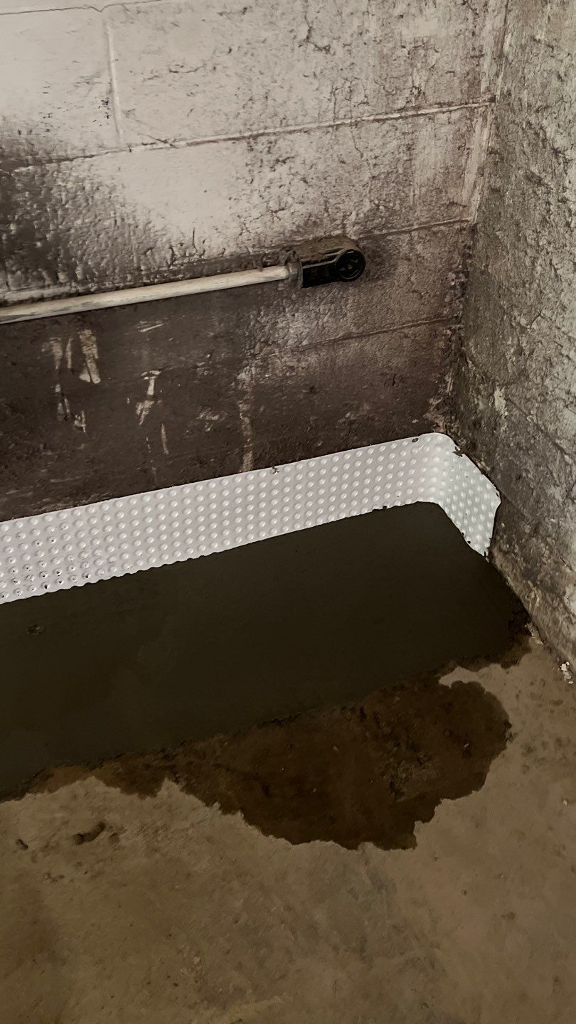 Interior drain tile system installation by ACE Waterproofing & Basement Solutions