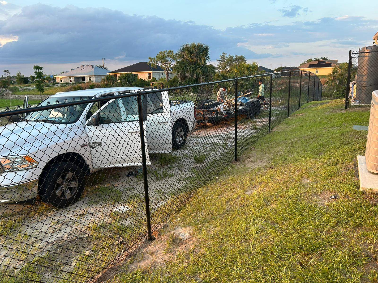 Black Chain Link Perimeter Fence and Utility Enclosure in Cape Coral by True Fence LLC