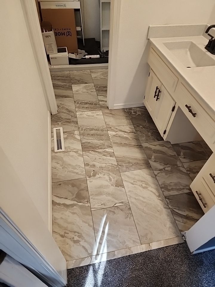 New shower, flooring, and countertop by The Shower Company