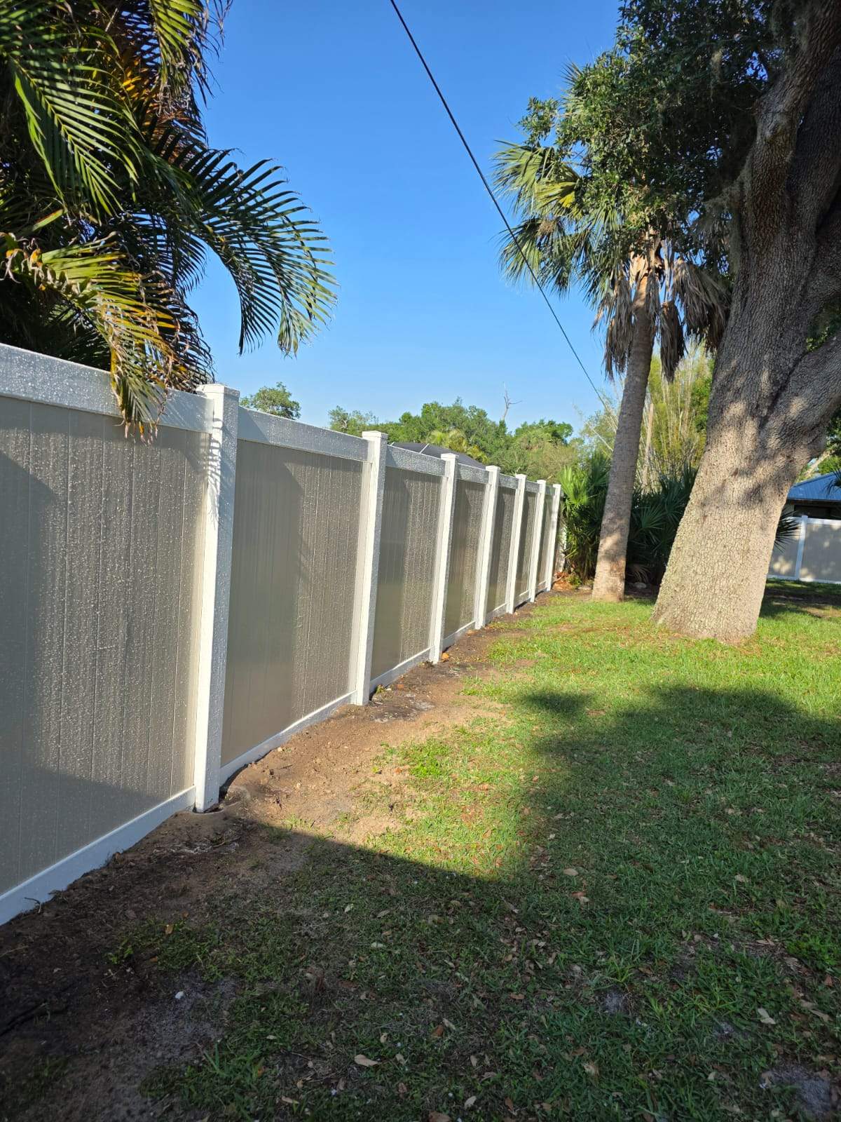 Two-Tone Vinyl Privacy Fence Installation in Port Charlotte by True Fence LLC
