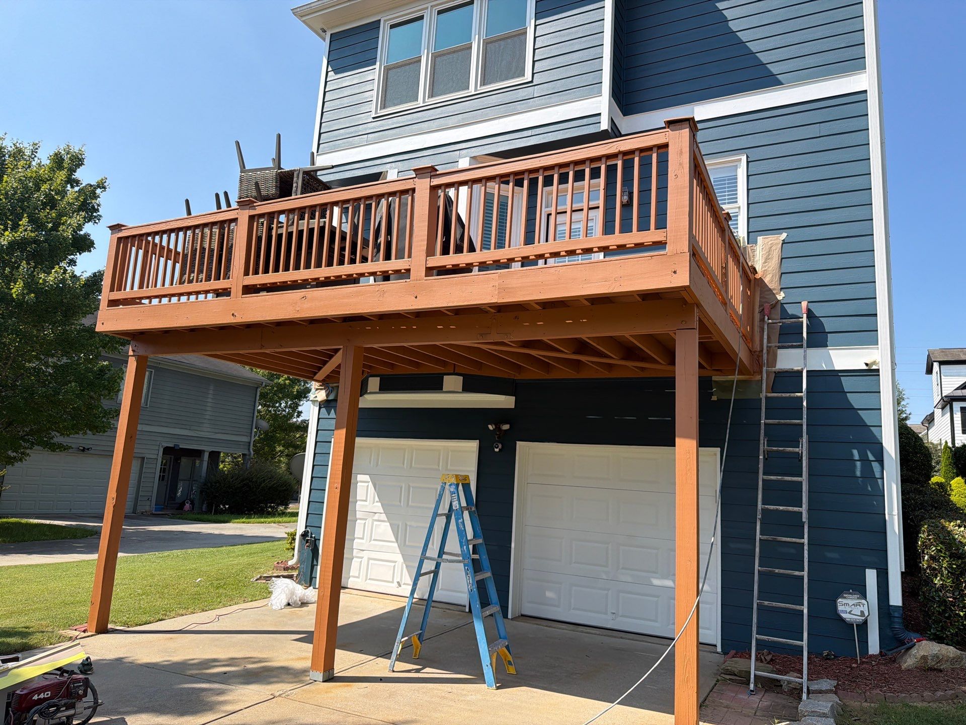 Atlanta Exterior Home Refresh with Blue Siding and Deck Staining by Swift Home Renovations 