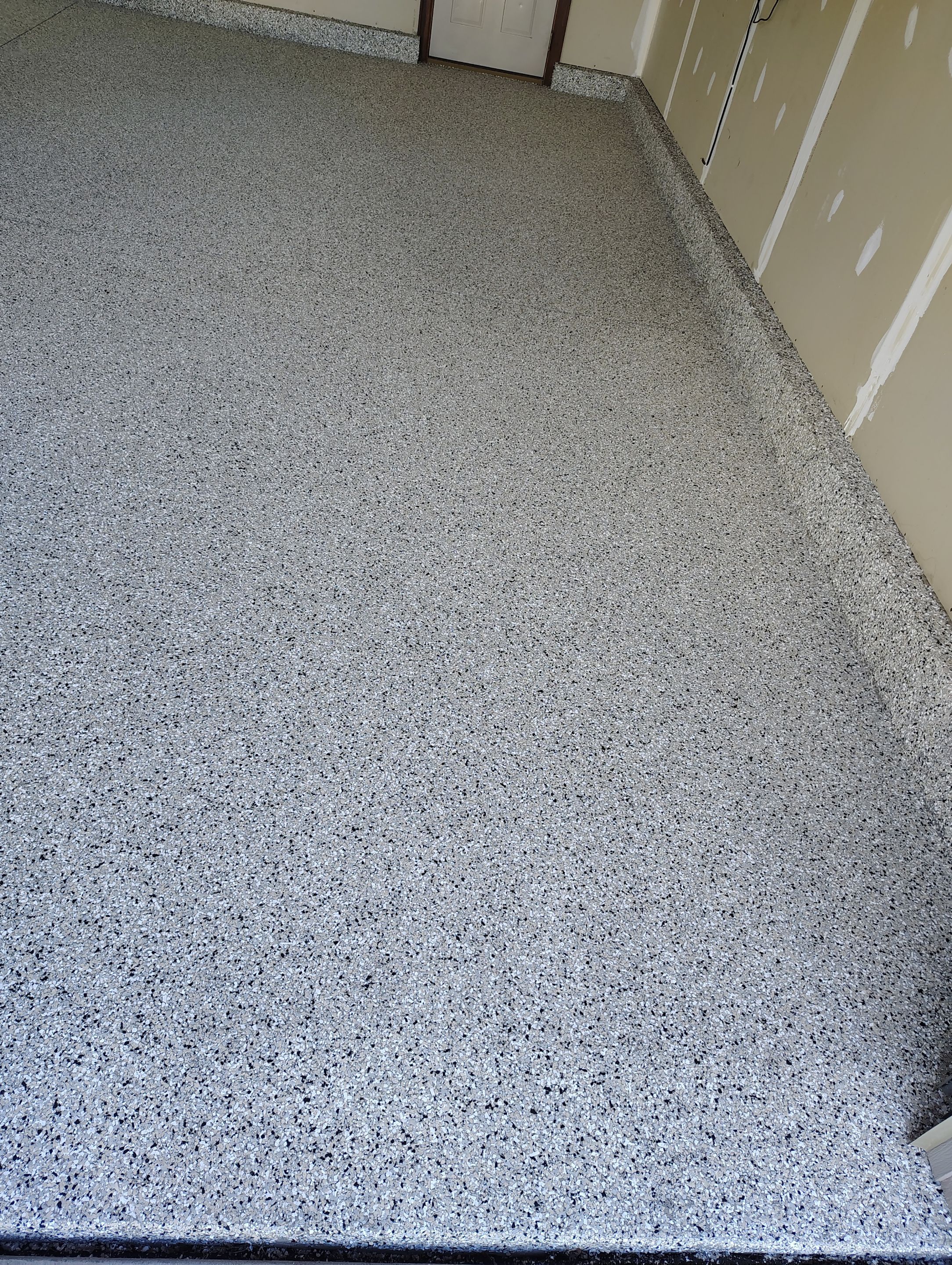 Multi-Car Garage Concrete Coating and Epoxy Finish in Sioux Falls by Select Painting, Coatings & Garage Cabinets