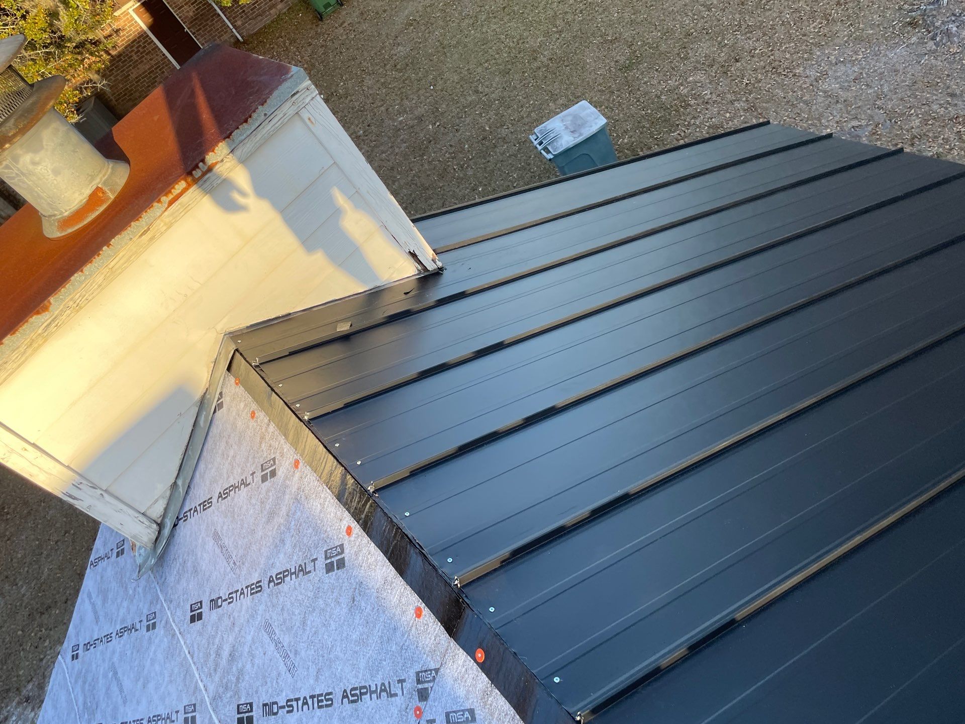 Residential Roofing Installation using Benton 26Ga 1inc Snapcock Metal Roof KYNAR Matte Black by Talya Roofing