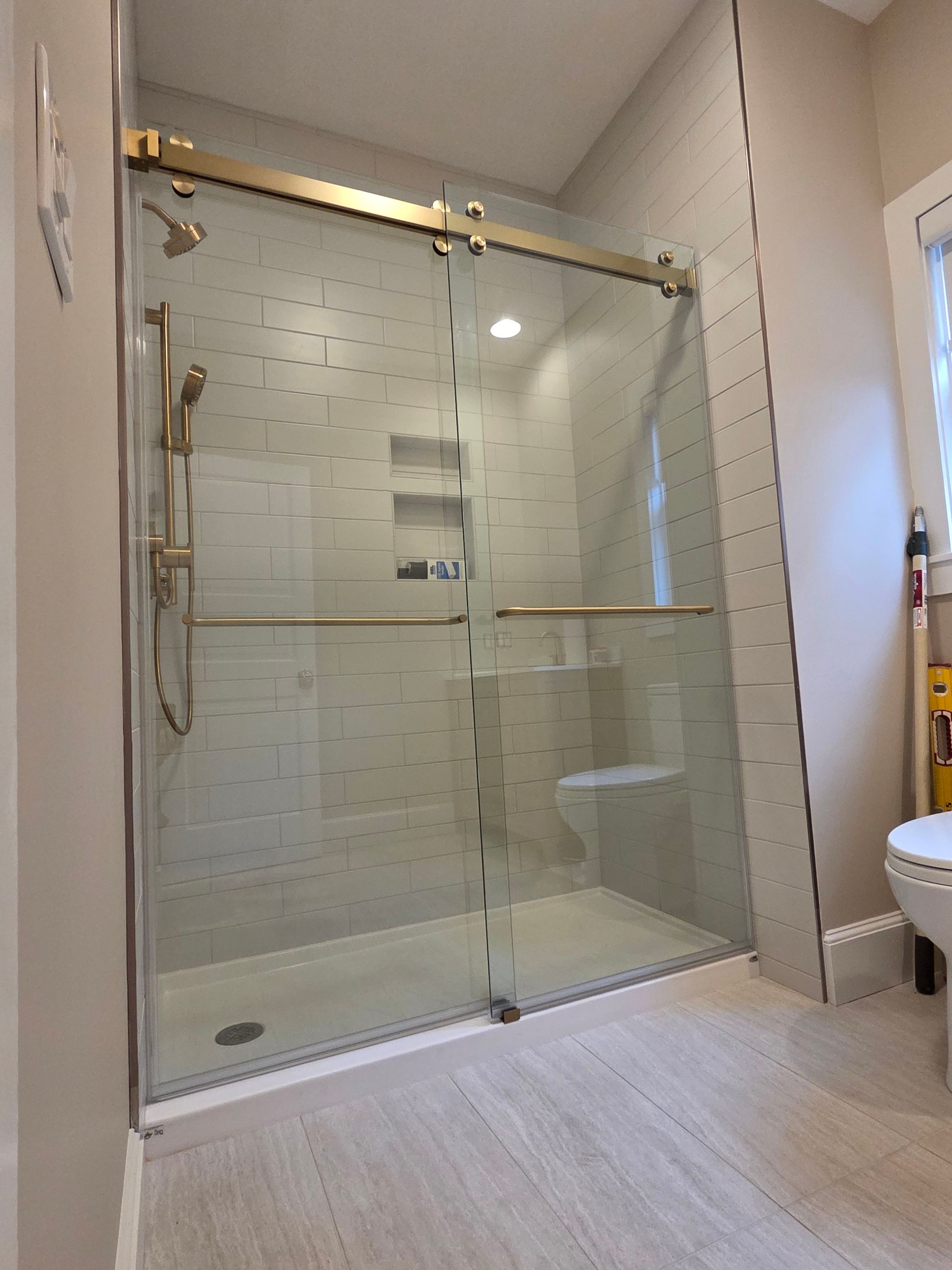 CRL Cambridge Series Dual Sliding Shower Enclosure — Installed in 3/8" Clear ShowerGuard Glass with Brushed Bronze Accents by Cheshire Glass Company