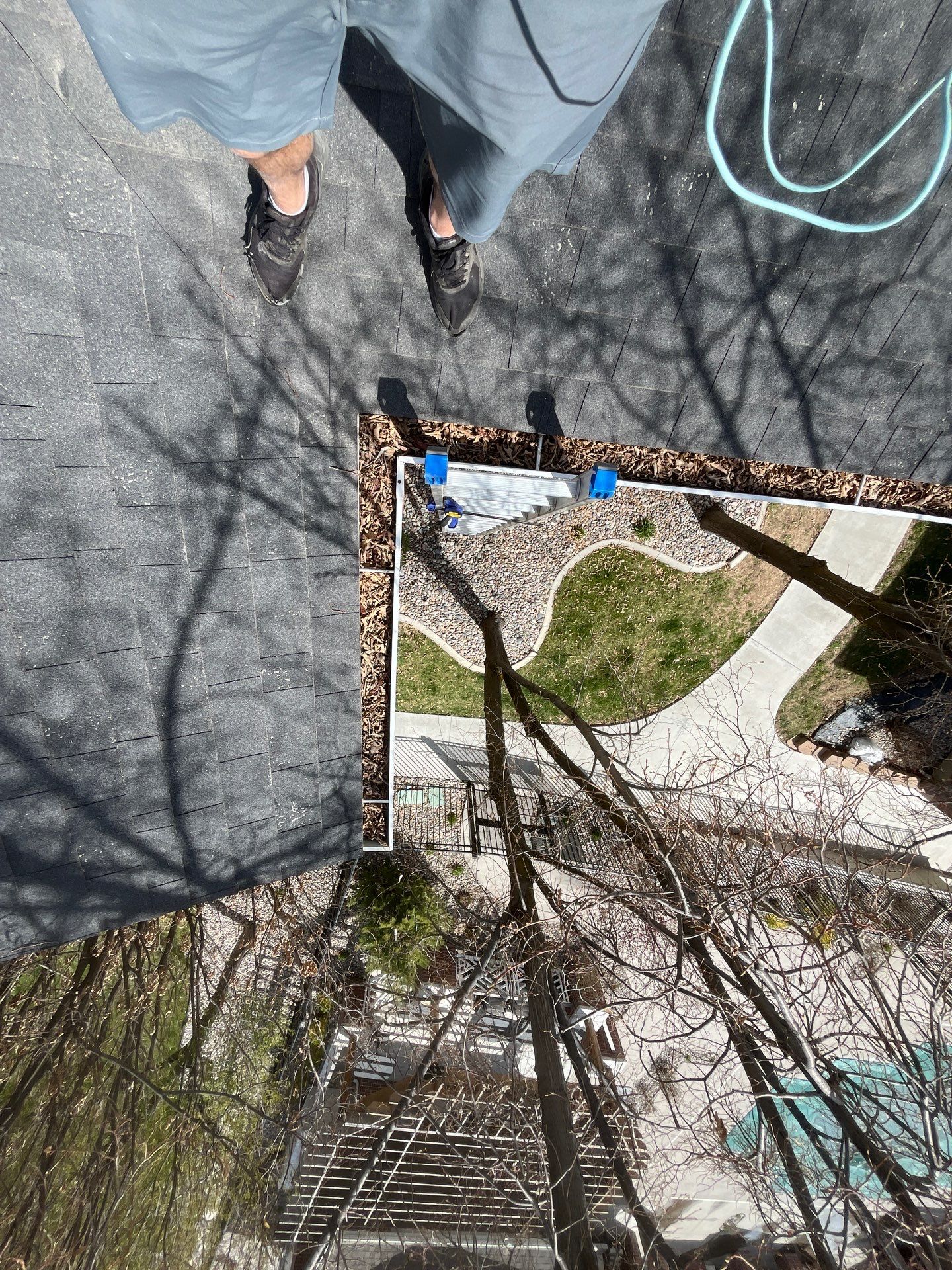HOA gutter cleaning in Logan, UT before photo showing full gutters