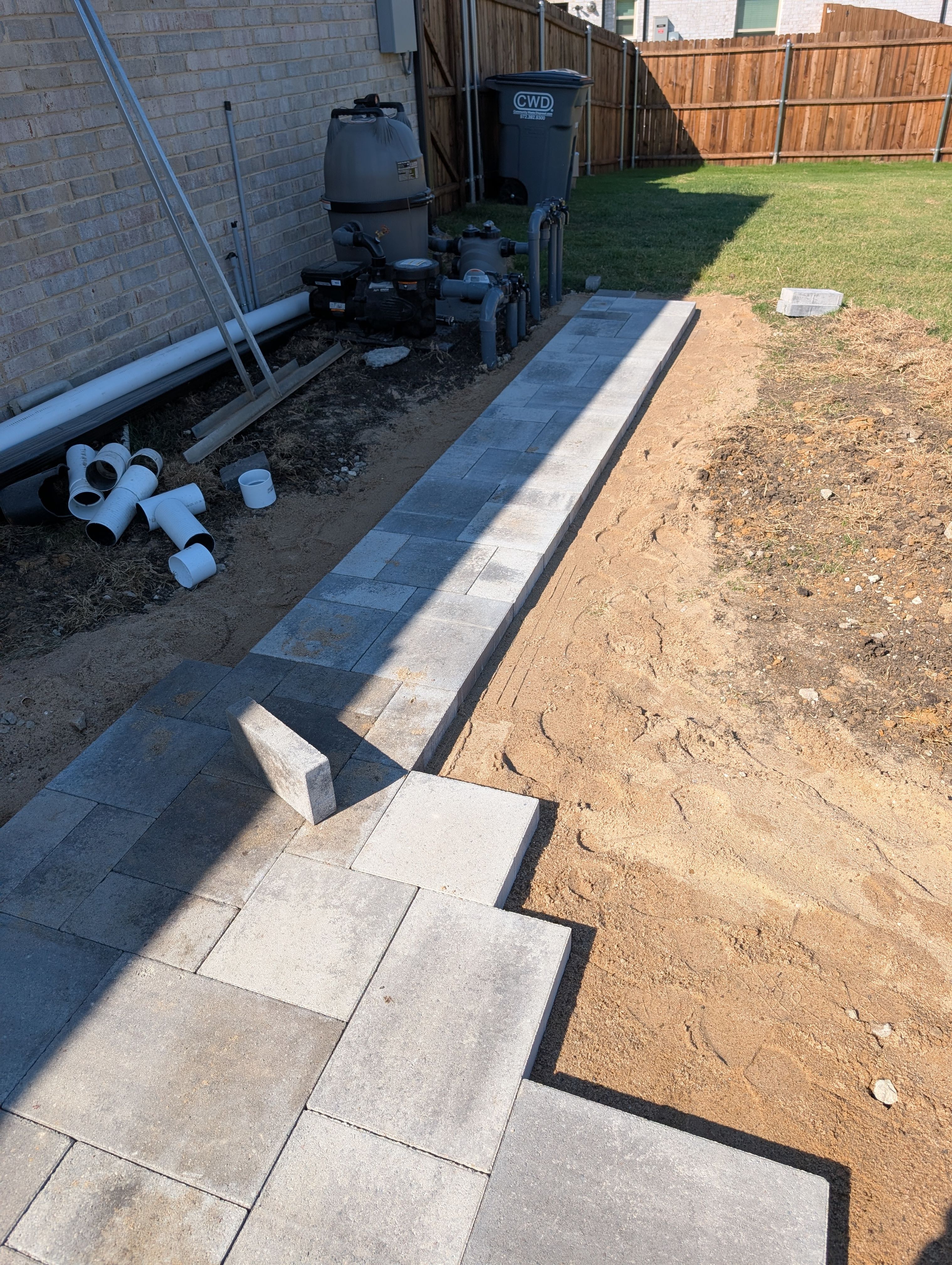 Freeform Pool with Raised Stone Accent Wall by Pinnacle Pools and Spas - DFW
