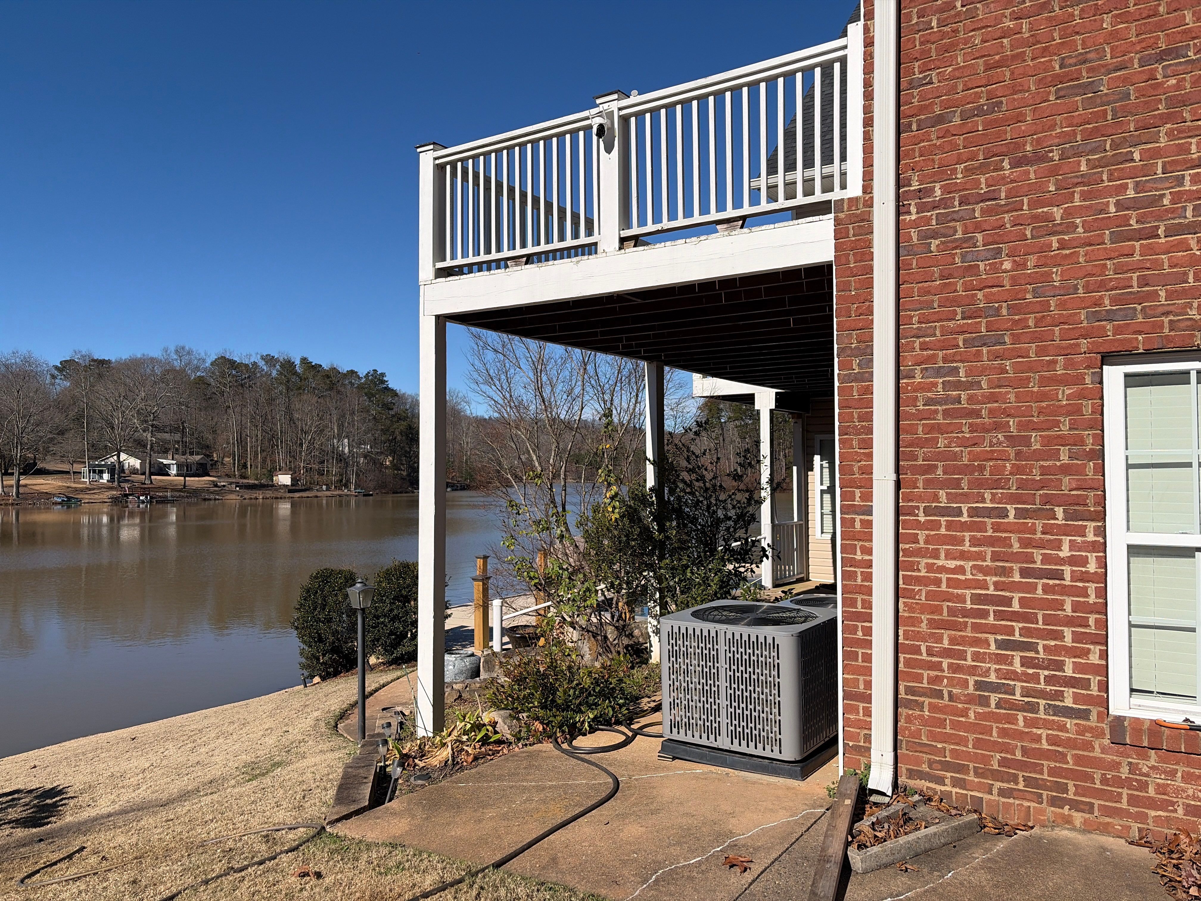 Cumming, GA Lake House Deck Resurface and Extension using Pressure Treated Pine and Skyline Cable Railing by Nelson Exteriors 