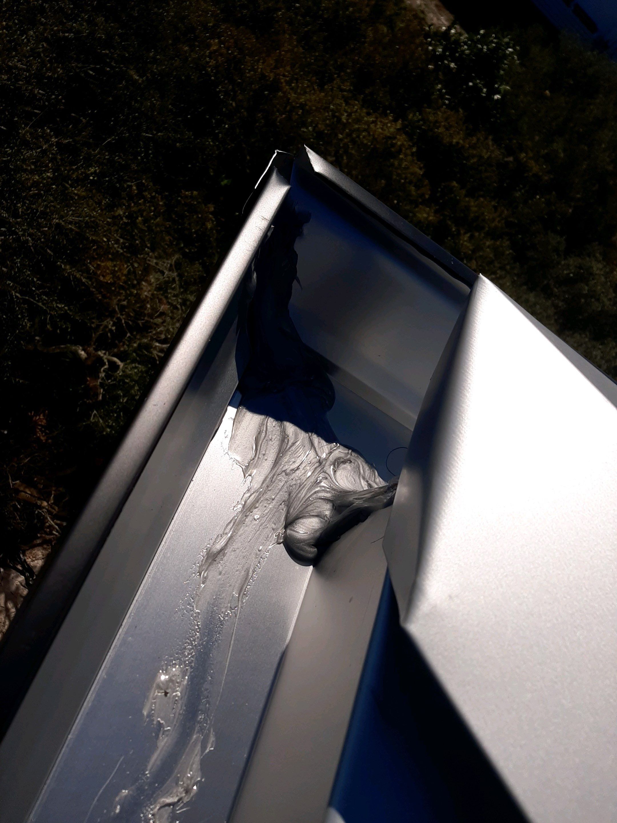 Seamless Gutter Installation Using Black Half Round Seamless Gutters by Gutter Professors