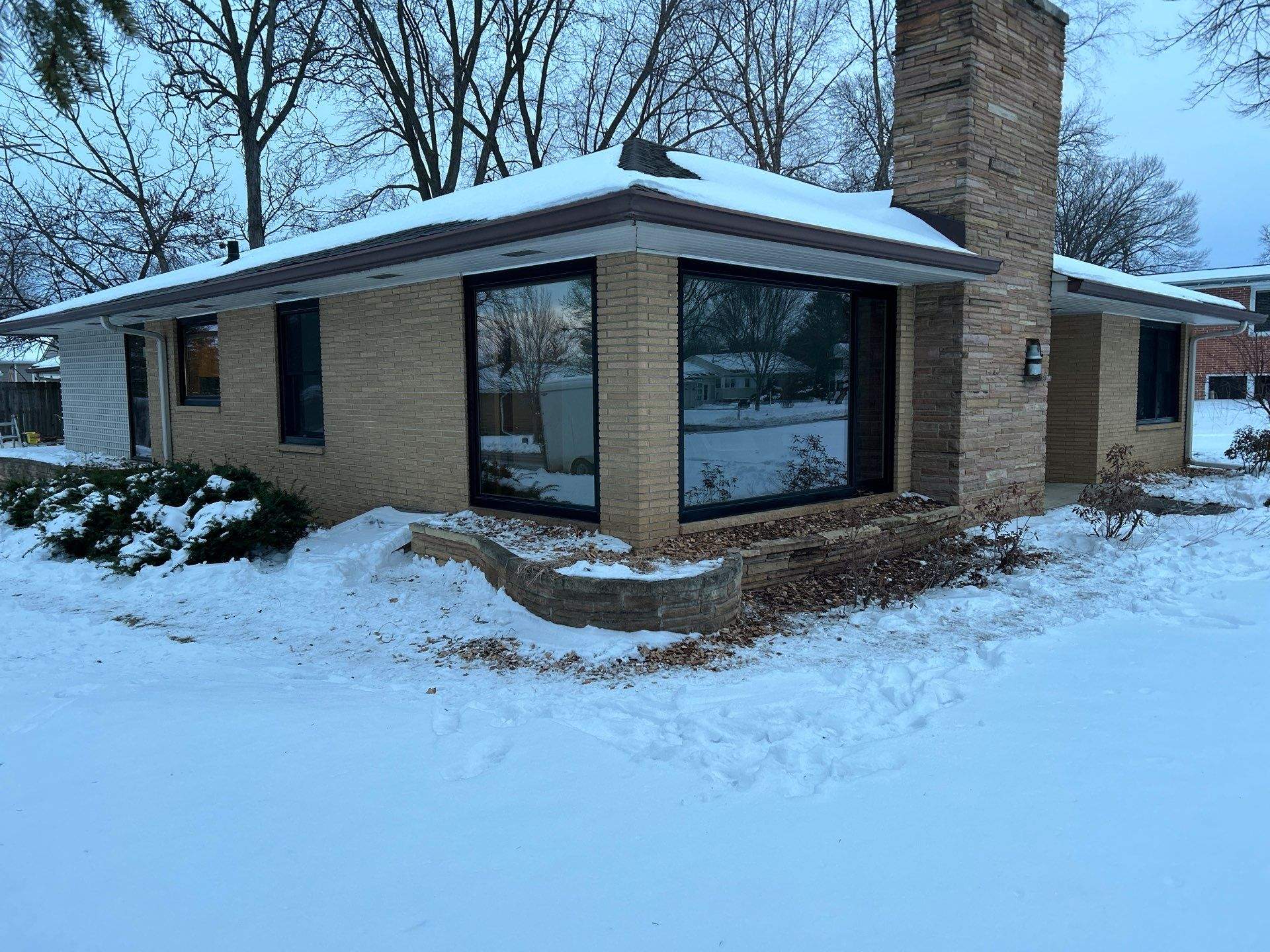 Black-Frame Pella Lifestyle Upgrade on a Partial Brick Home by United Windows and Siding LLC