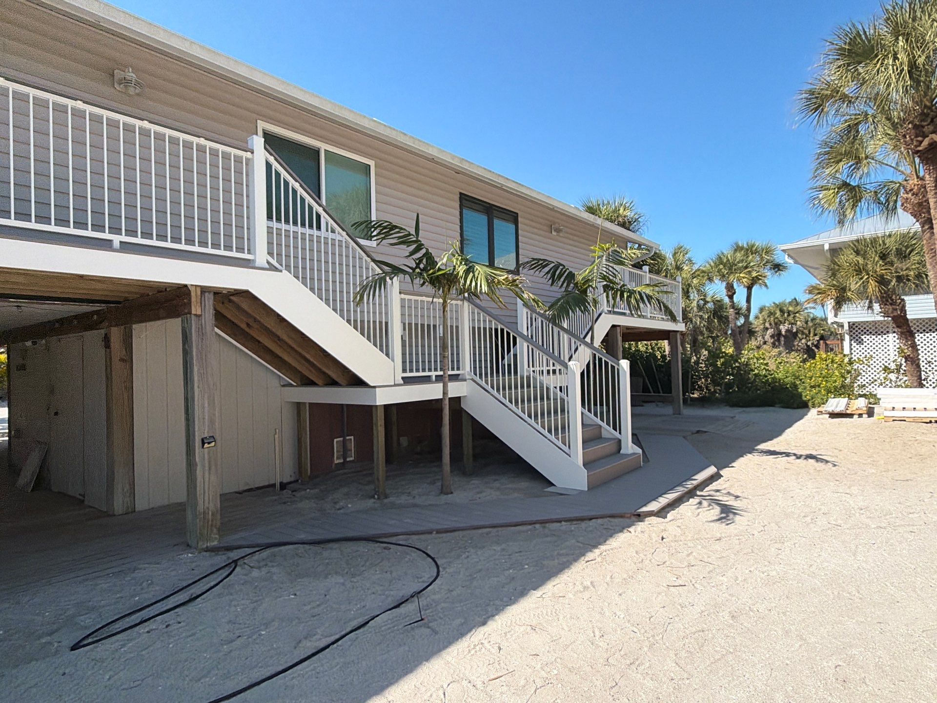 Elevated Home Deck Reconstruction With White Aluminum Railings in Placida by Smirnov Construction Inc